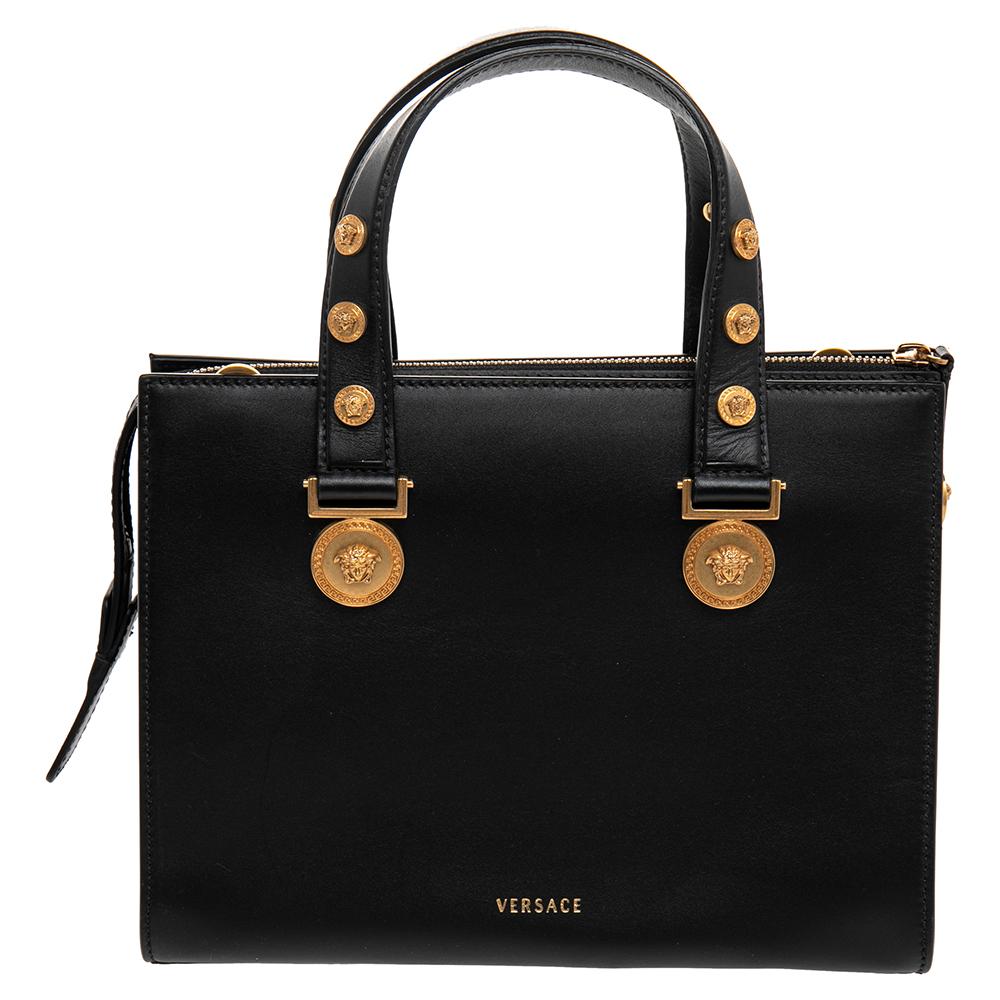 This Versace Tribute tote in black leather has an alluring design. Beautifully crafted, the bag comes with a highly durable exterior detailed with gold-tone motifs for an unmissable Versace signature. Equipped with a leather interior, two handles,