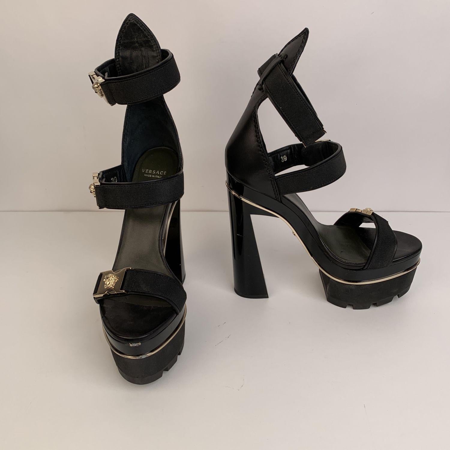 Stunning Versace high platform sandals from the 2016 Spring/Summer Collection. Crafted in black leather with acrylic heels and structure. They feature a strappy design, gold metal buckle with Medusa detailing and gold-tone piping. Leather insole.