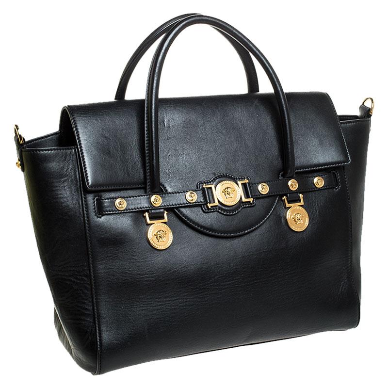 Sophisticated and luxe, this bag from Versace definitely needs to be on your wishlist. The bag is crafted from leather in a lovely black shade and it features a structured silhouette. It flaunts dual handles, a removable shoulder strap and the