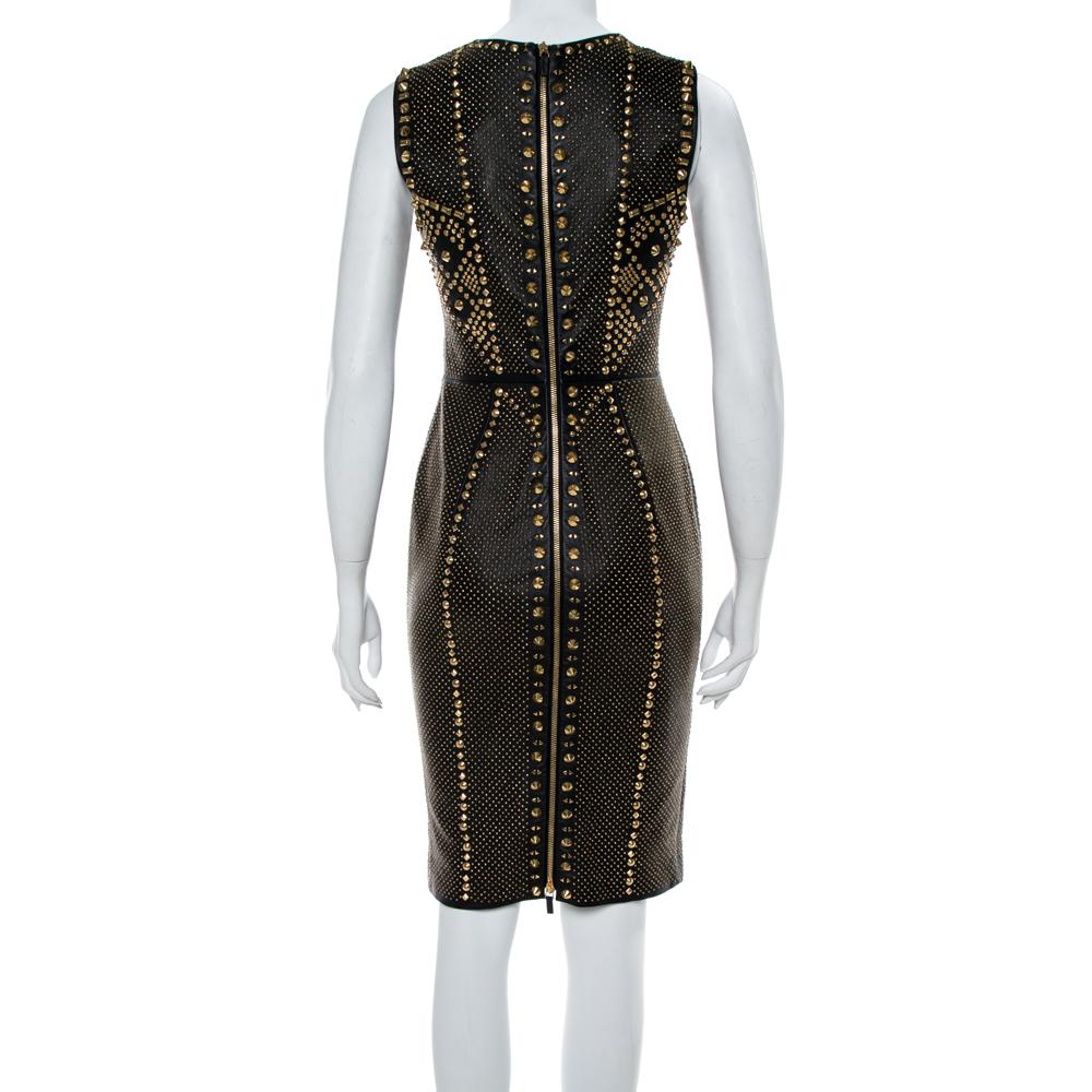 From Versace's Spring 2012 Ready-To-Wear collection, this gorgeous dress brings a strong, bold look. It comes in black with a well-fitting construction and metal studs in gold-tone embellished all over. The dress is a runway dream that can be
