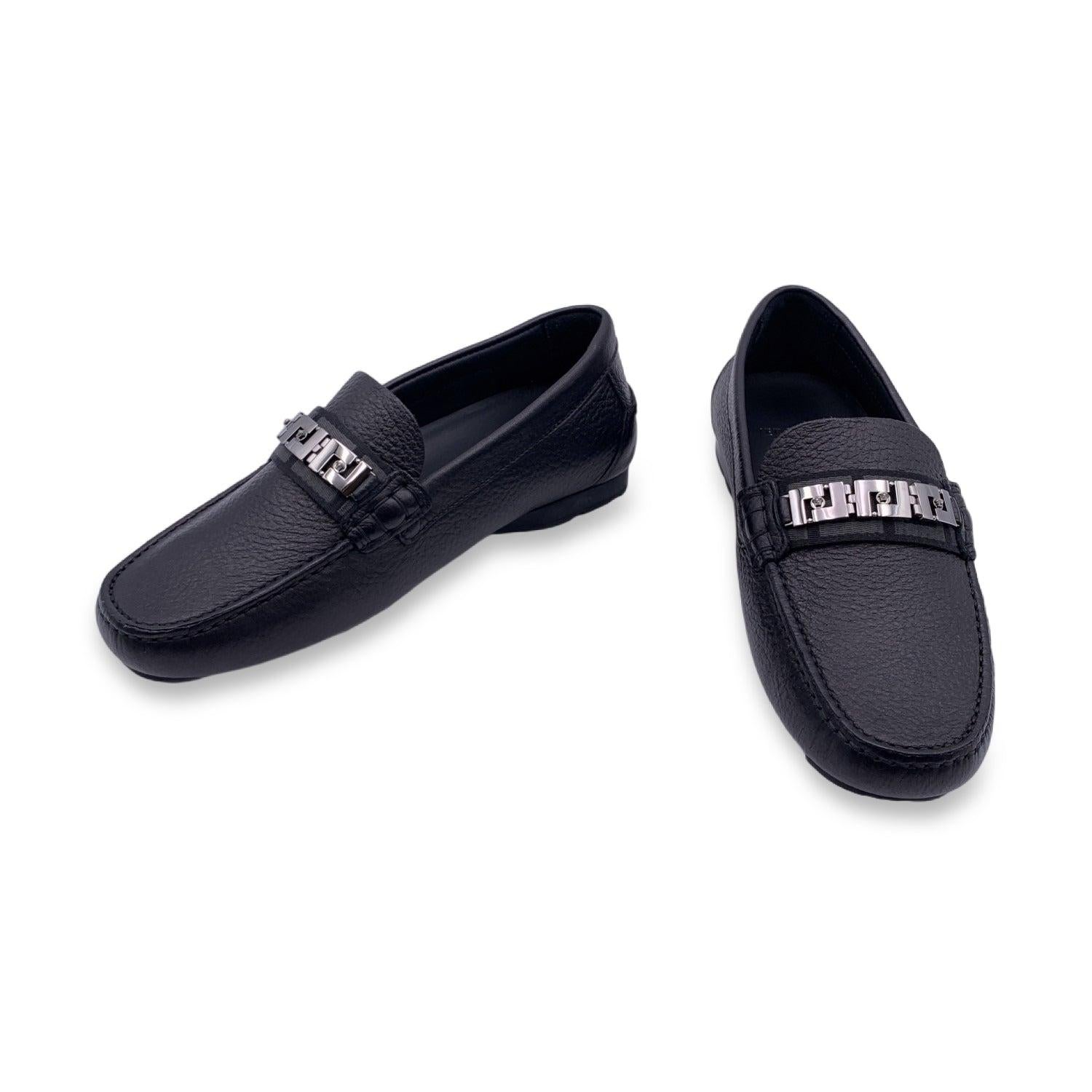 Beautiful Versace car shoes. Crafted in black leather with rutenio greek and Medusa detailing on top. They feature a round toe and slip-on design. Rubber sole. Made in Italy. Size: EU 38.5 (The size shown for this item is the size indicated by the