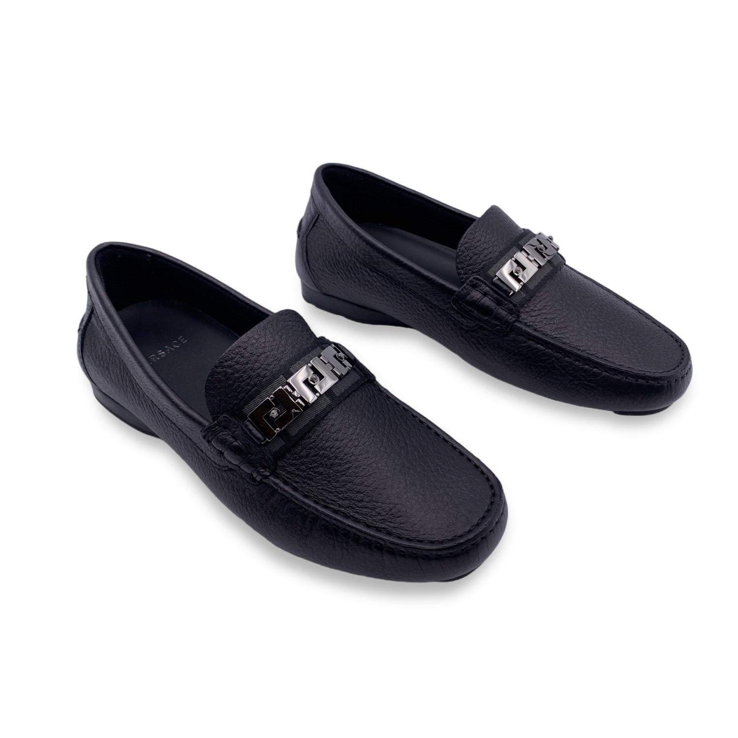 Beautiful Versace car shoes. Crafted in black leather with rutenio greek and Medusa detailing on top. They feature a round toe and slip-on design. Rubber sole. Made in Italy. Size: EU 38.5 (The size shown for this item is the size indicated by the