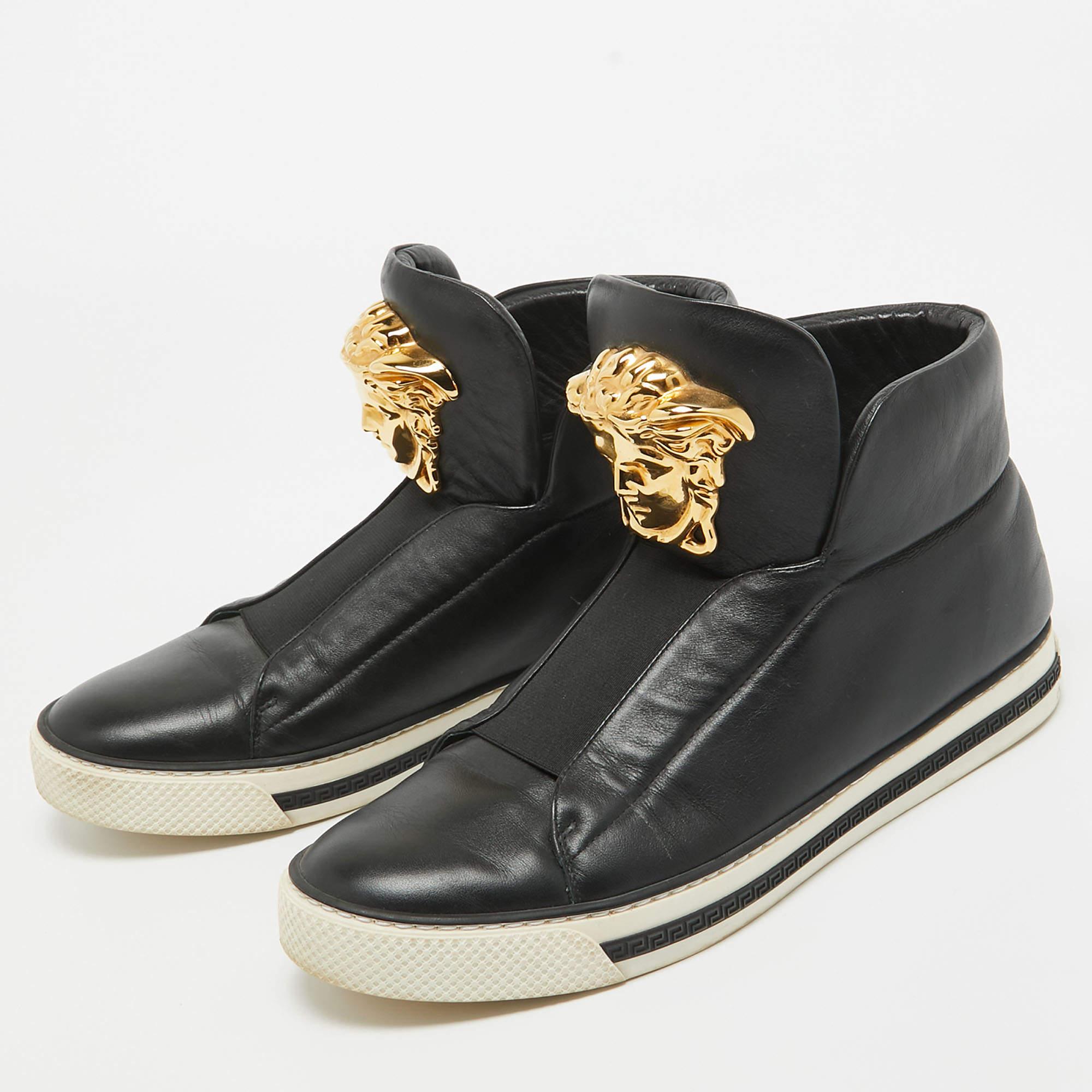 Sneakers are sought after for reasons like comfort ease and casual style. These Versace ones fit right in as they are stylish and snug. They come crafted from black leather into a design of elastic panels and the Medusa logo on the front. They are
