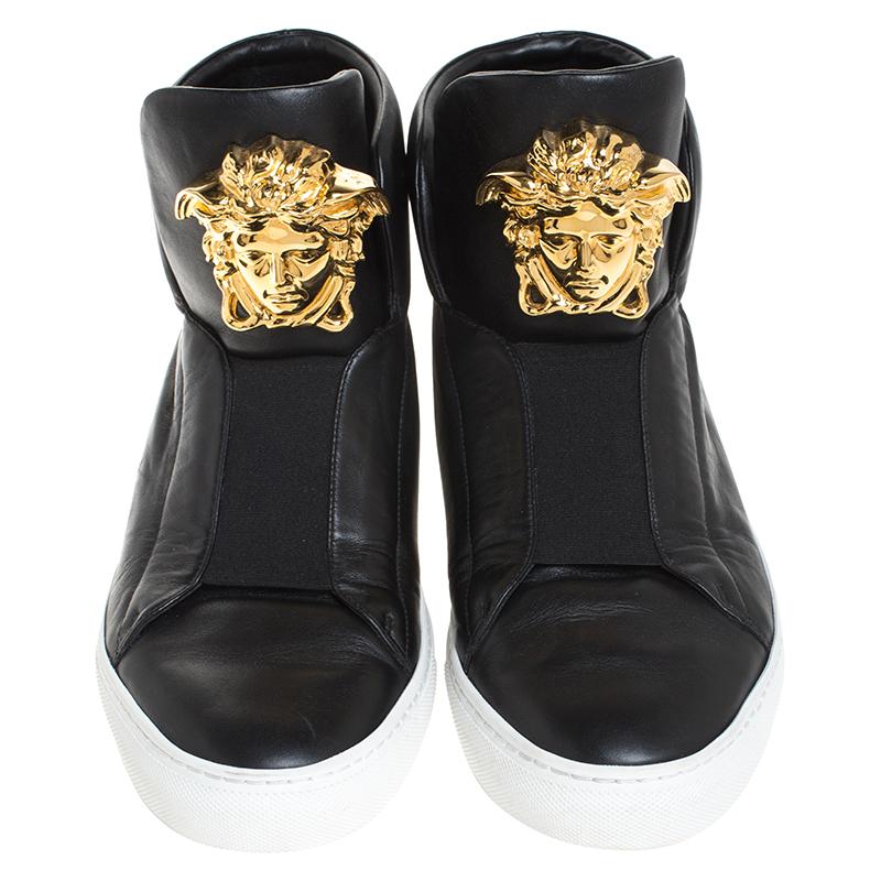 Sneakers are sought-after for reasons like comfort, ease and casual style. These Versace ones fit right in as they are stylish and snug. They come crafted from black leather into a design of elastic panels and the Medusa logo on the