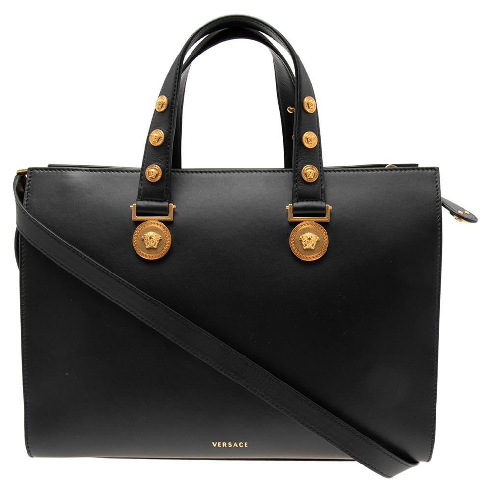 Elevate the look of your outfit by carrying this tote from Versace. It is designed using black leather on the exterior, with Medusa accents studded throughout. It has a sturdy silhouette that features gold-toned hardware and a leather-lined