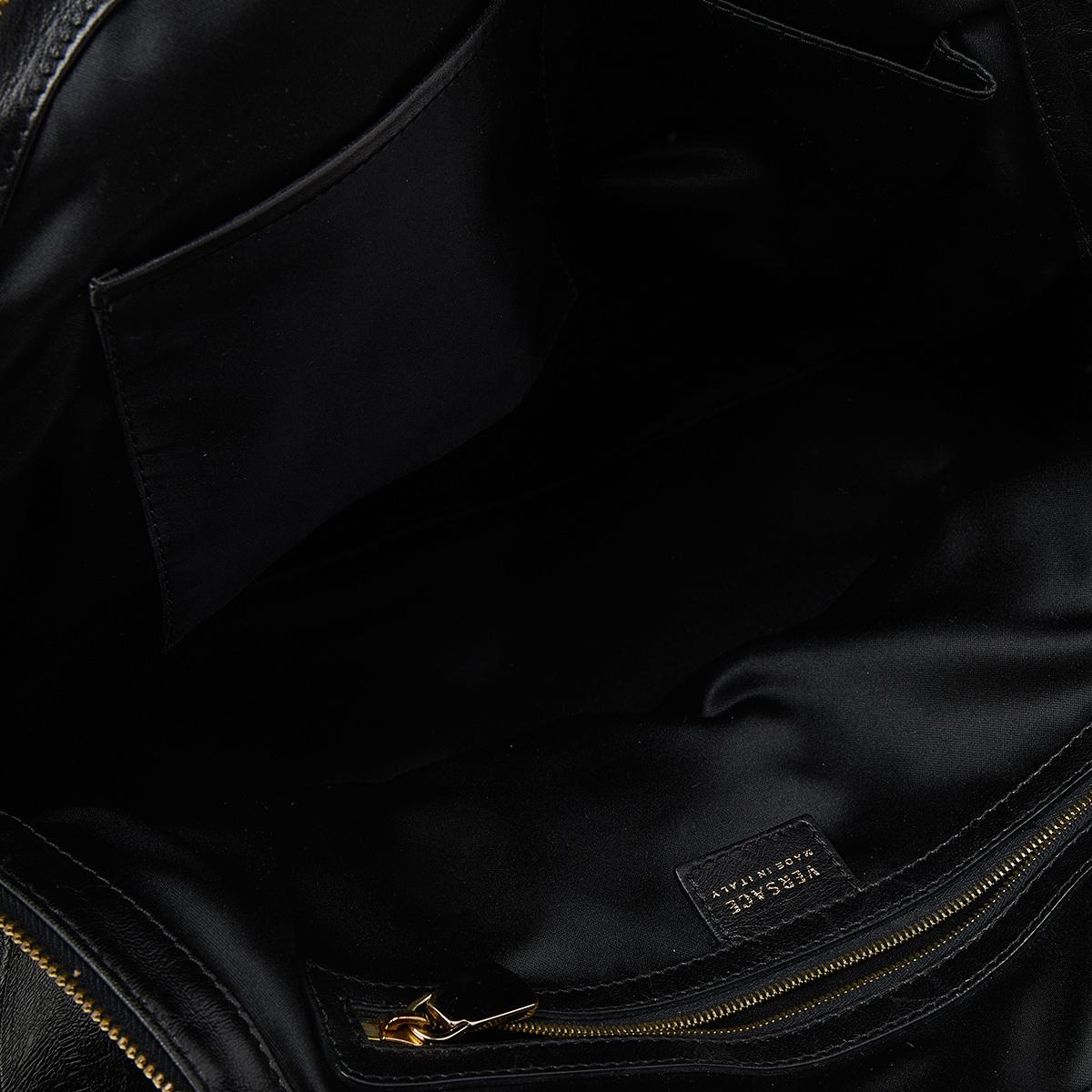 Designed from leather, this Versace satchel in black will complement your everyday look. It features two flat handles, the brand plaque at the front, metal studs to protect the base, and a spacious satin interior.

Includes: Original Dustbag