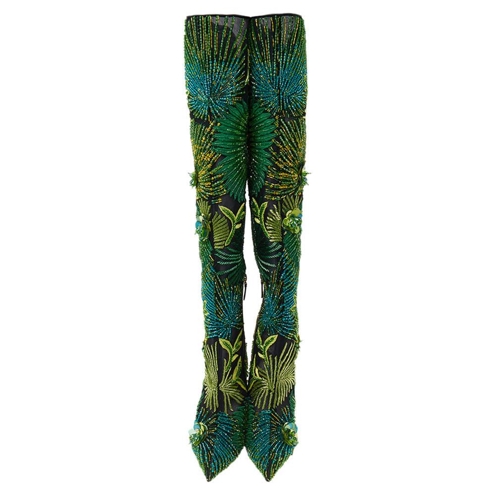 Granting versatile aesthetic and quirkiness to their designs, the House of Versace skillfully crafts memorable pieces that never go out of style. These gorgeous 'Over The Knee' boots from Versace are crafted using black mesh and green