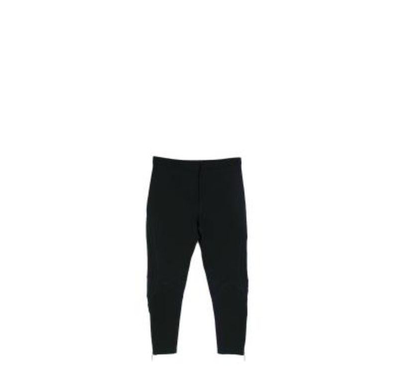 Versace Black Mesh Panelled Tapered Trousers

- Tapered leg, with sculpted mesh panels and directional seaming
- Gold-tone metal ankle zips
- Exposed cover seam stitch details
- Mid-rise, zip fly

Materials: 
This item does not have a care label,