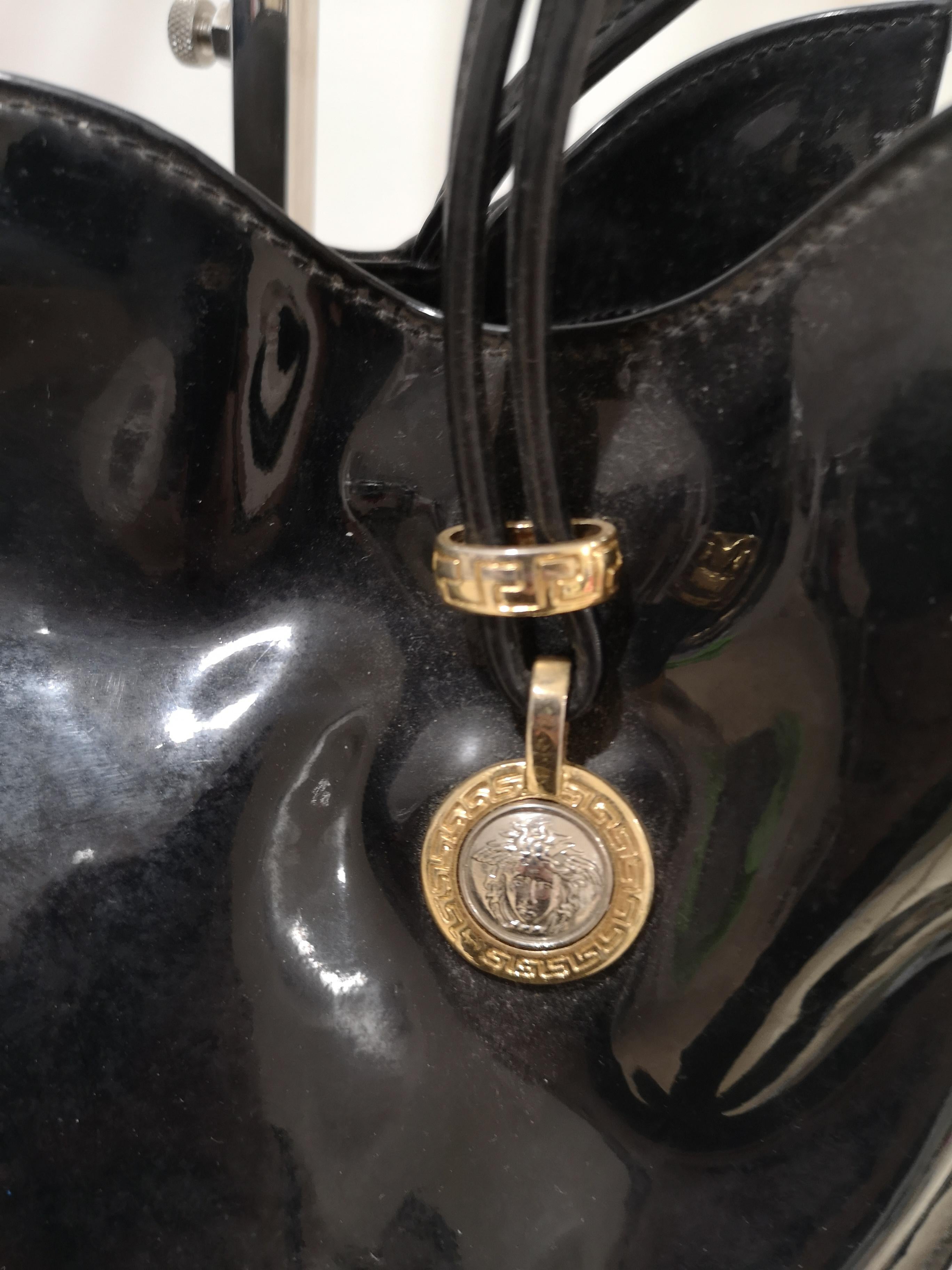 Versace black patent leather shoulder bag
embellished with silver and gold medusa logo
totally made in italy
meaurements: 
33 * 28 cm * depth 7 cm
heigh: bag and handle 72 cm 
