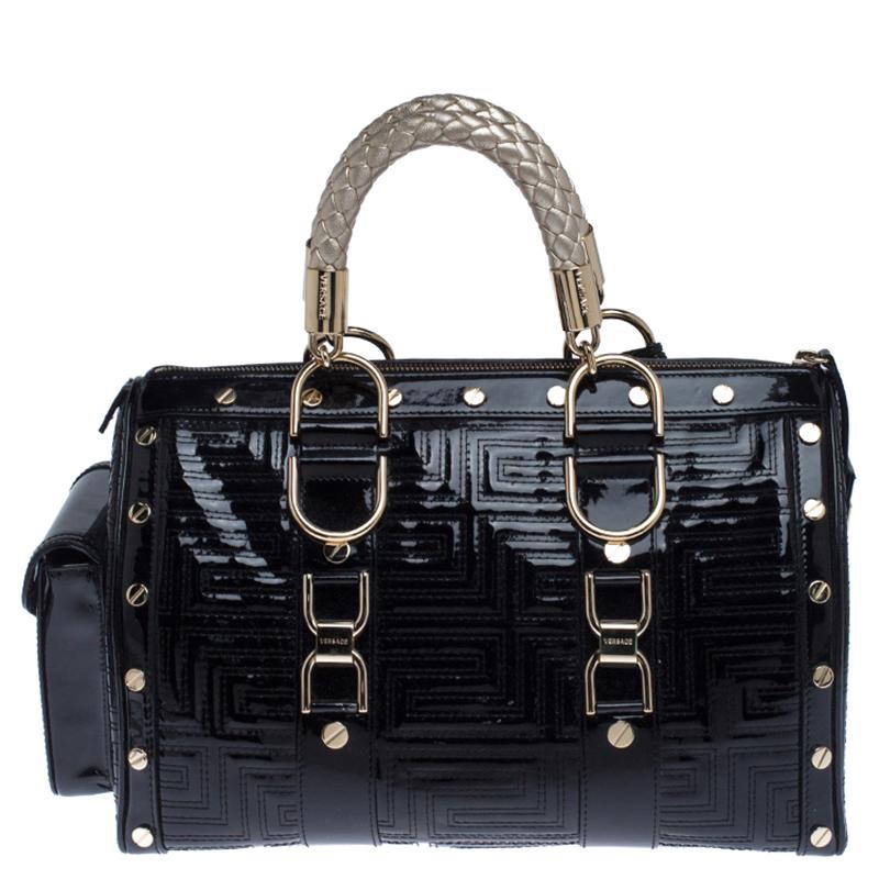 This bold and eye-catching Versace Snap Out Of it satchel is sure to make heads turn. Crafted from quilted patent leather the bag is accented with a Gianni Versace Couture plate and gold-tone studded hardware. It features dual handles and a top