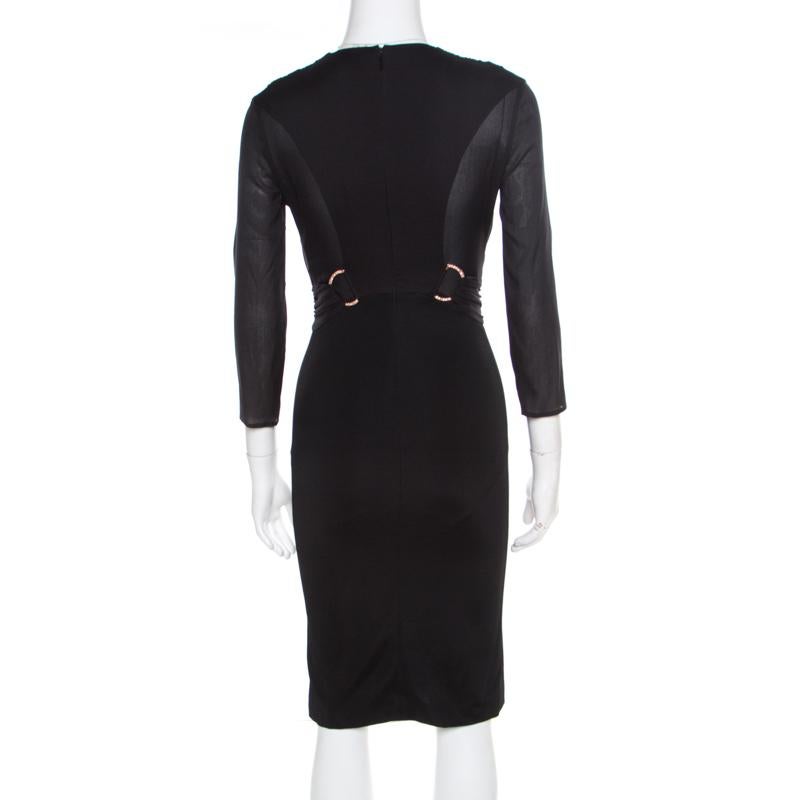 You'll love wearing this dress from Versace as it will give you a perfect fit and accentuate your body in a graceful way. The black dress carries long sleeves, a back zipper and a V neckline. You can team it with a pair of statement