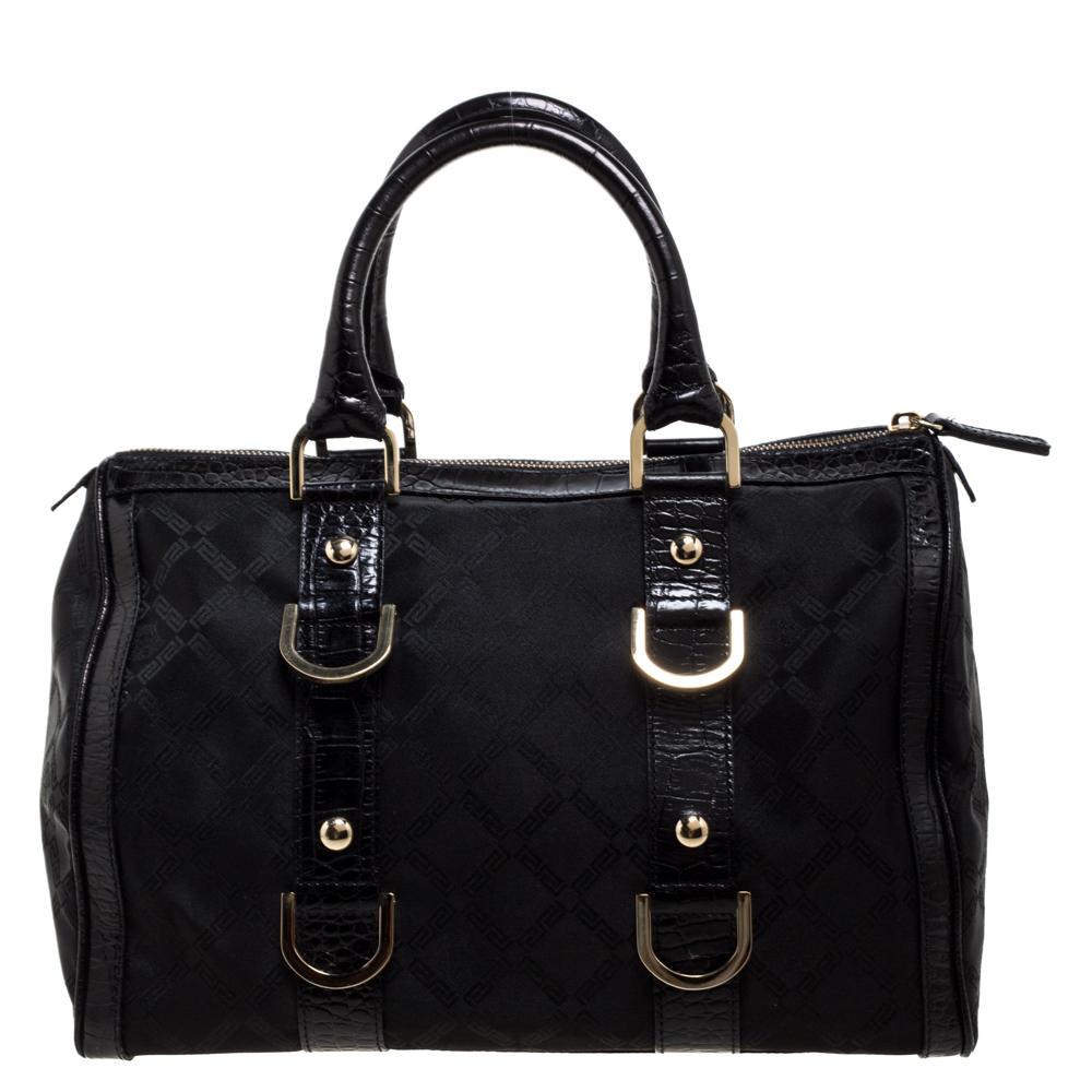 A truly elegant piece to add to your collection, this Boston bag by Versace comes crafted from black signature coated fabric and croc-embossed leather. It features a top zip closure, two handles, gold-tone hardware, and a spacious interior to house