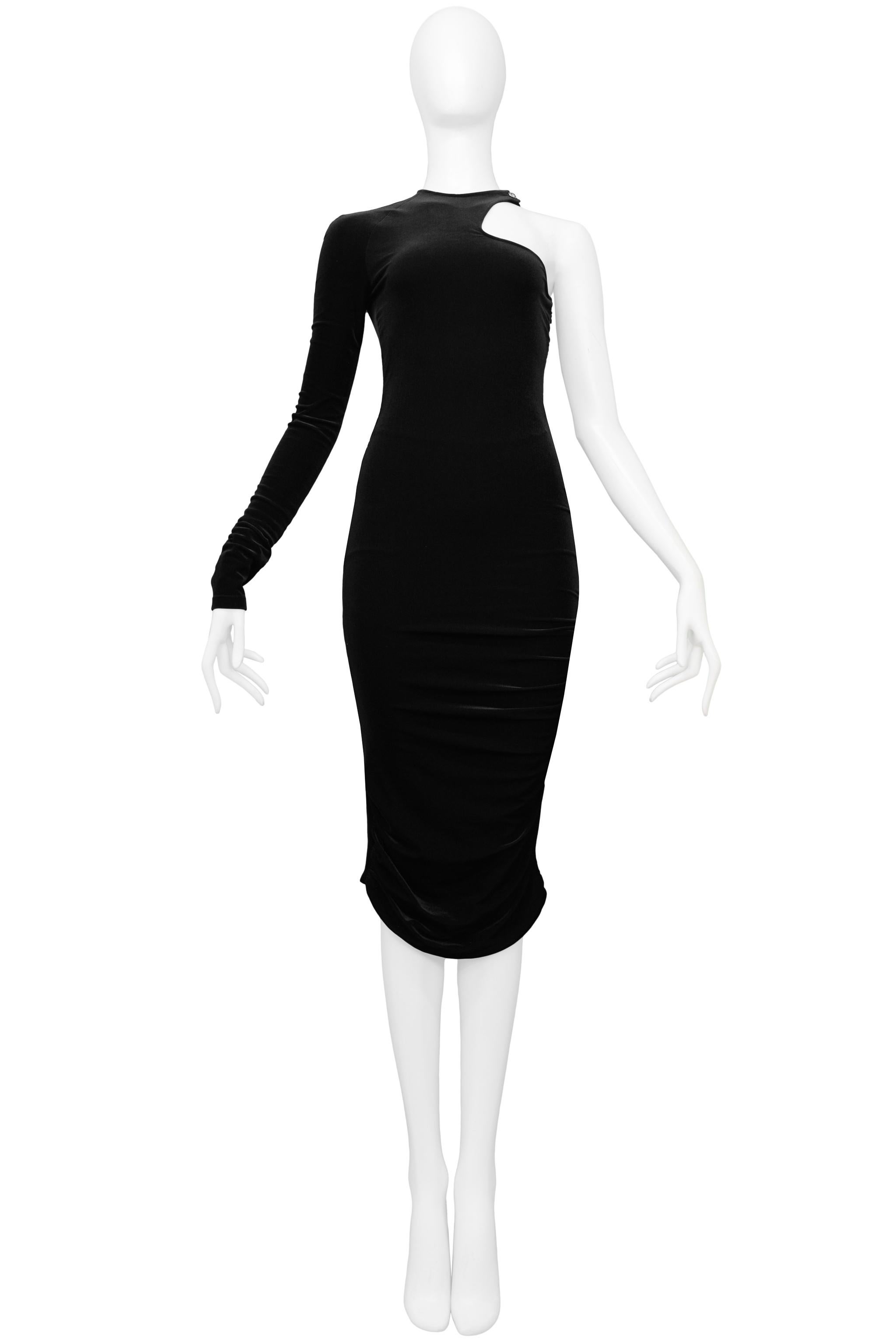 Resurrection is pleased to offer a Versace black velvet body-con dress featuring one sleeve, high neck with side cutout and silver-tone Medusa snap, side zipper, internal mesh half bodysuit, back cutout, and ruched sides at the hem. 

Versace
Size