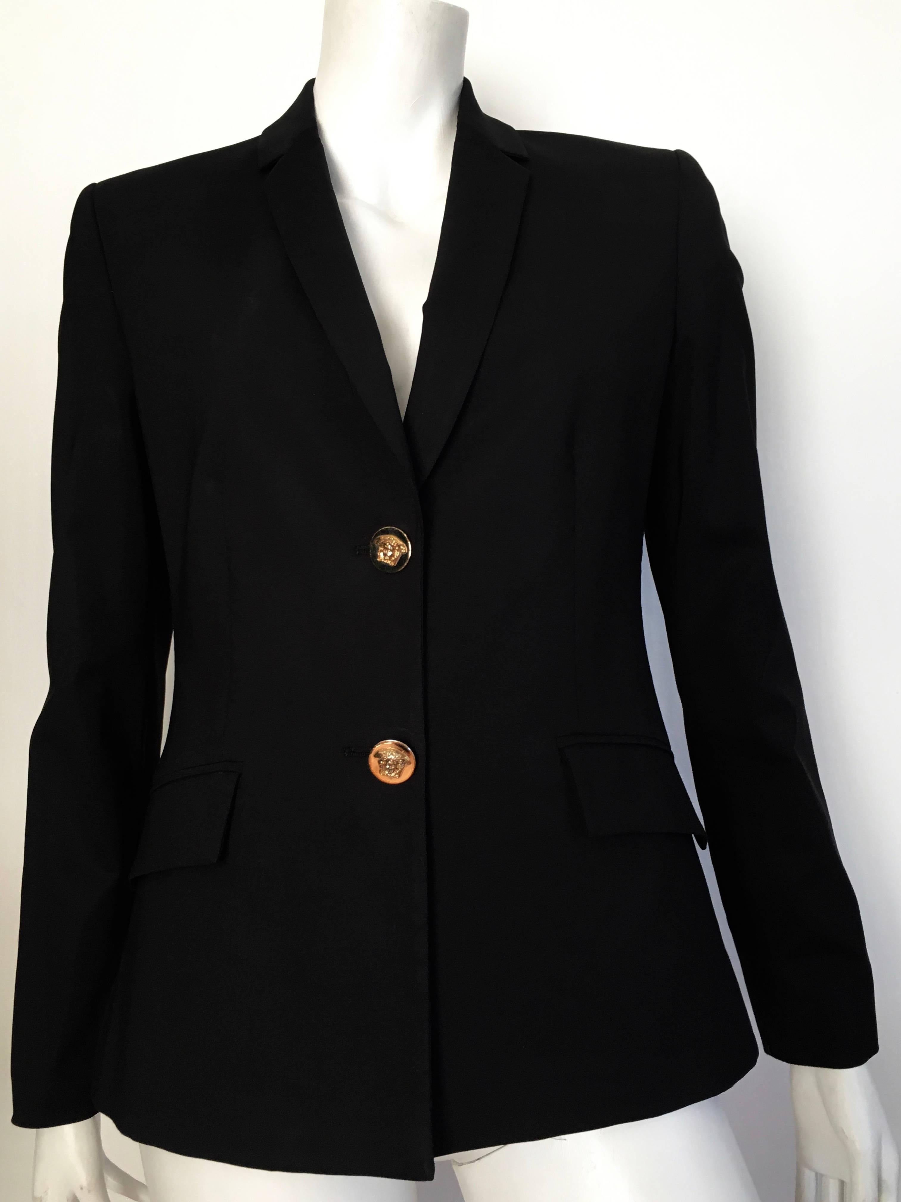 Versace black wool jacket is an Italian size 44 and fits a size  6. There are two gold Medusa front buttons and jacket is lined with iconic Medusa fabric.  Wear this black wool Versace jacket with your 501 Levi's or over your maxi Missoni