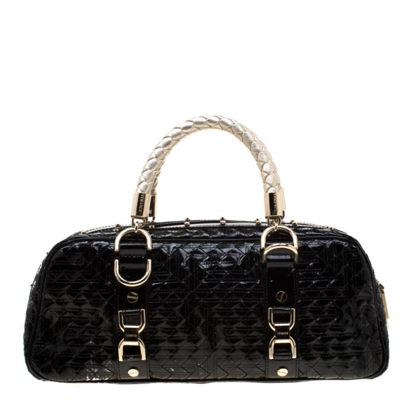 Woven to perfection, this Versace 'Snap Out Of It' satchel is in patent leather. It features dual braided top handles, gold-tone hardware, buckle detailing and the metal brand plaque on the front. The top zip closure opens to a fabric-lined interior