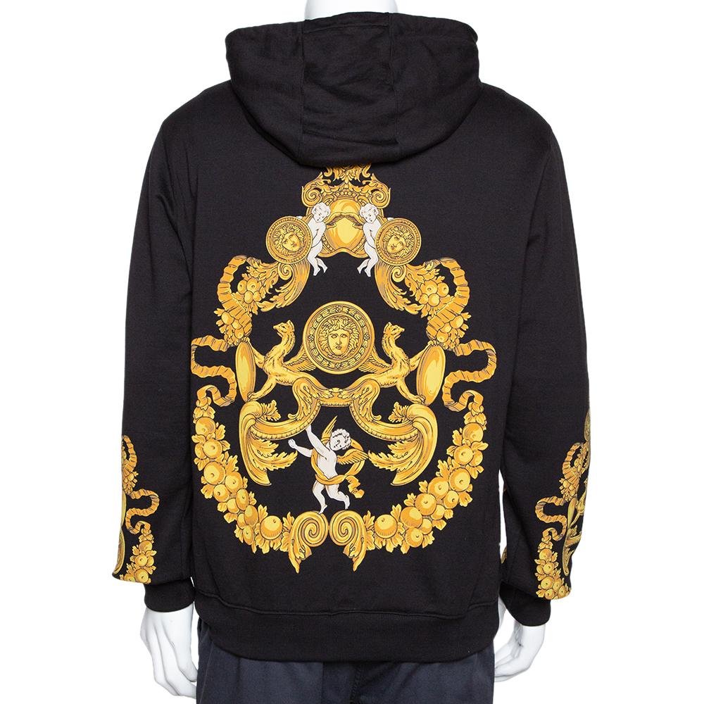 This black hoodie by Versace is a perfect pick for a relaxed day. It is crafted from 100% cotton and keeps you comfortable. It features long sleeves and signature baroque prints. The yellow of the pattern contrasts well with the dark background. It