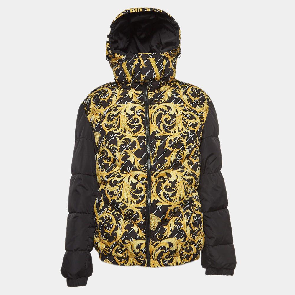 The Versace jacket is a luxurious fashion statement. Featuring a bold baroque print, it's crafted from high-quality nylon. The reversible design offers versatility, while the puffer style ensures warmth and comfort, making it a standout piece in