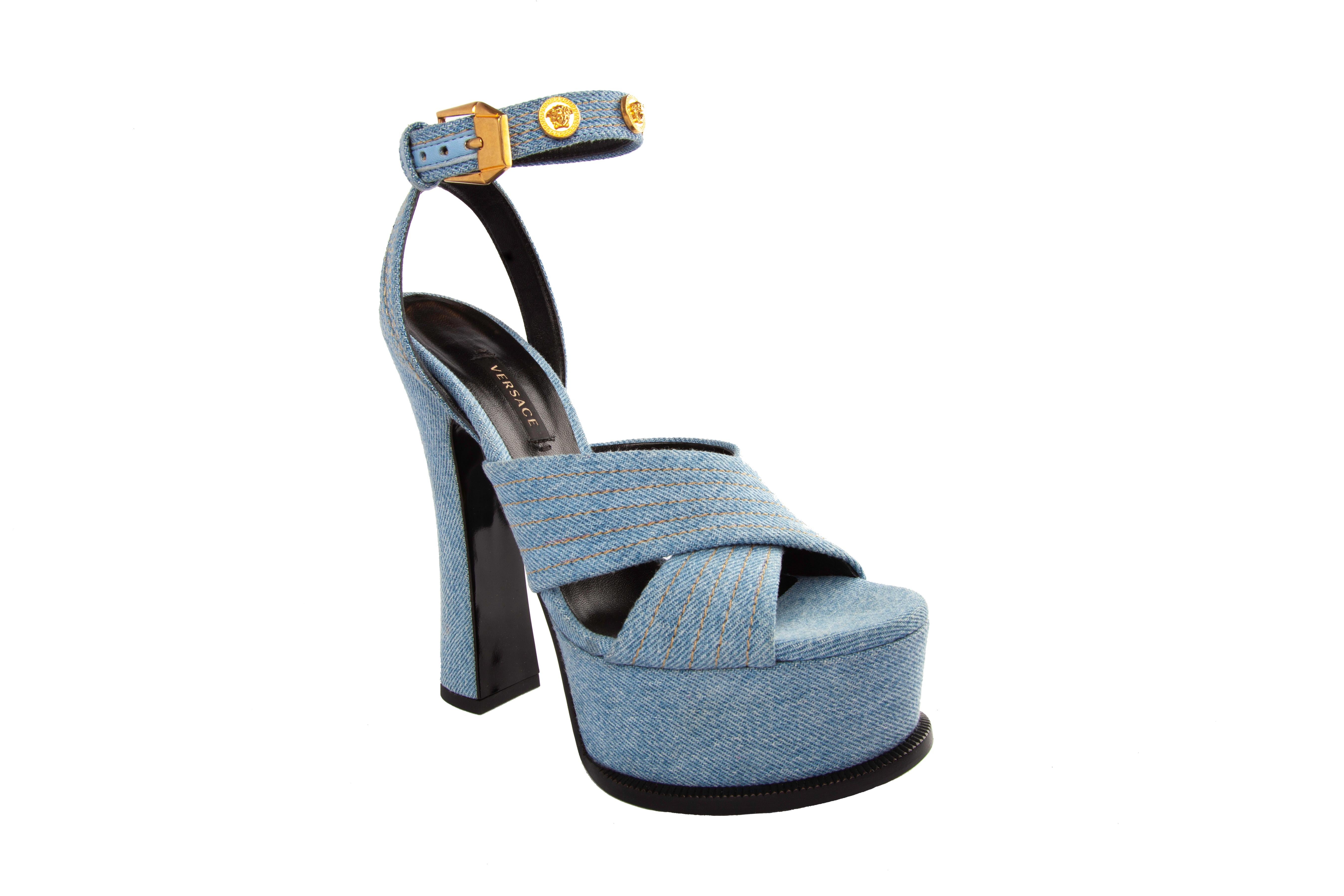 Versace Blue Denim High Heel Platform Sandal With Gold Tone Hardware Size 38

These Versace sandals feature a light blue denim fabric, gold tone Medusa studs, and an adjustable ankle strap. This pair was the store display model, so it shoes very