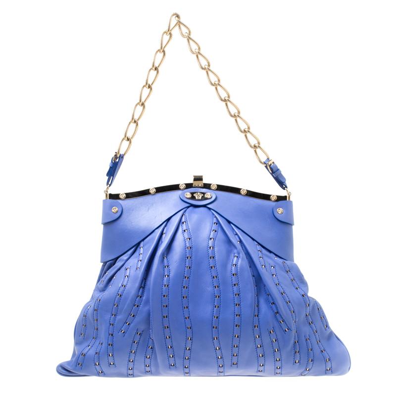 Flaunt a grand style with this fine bag. It is crafted from blue leather and it has waves looped with metal, gold-tone metal frame on top and mirror accents on the front. Held by a chain, this bag is surely a great buy.

Includes: The Luxury Closet