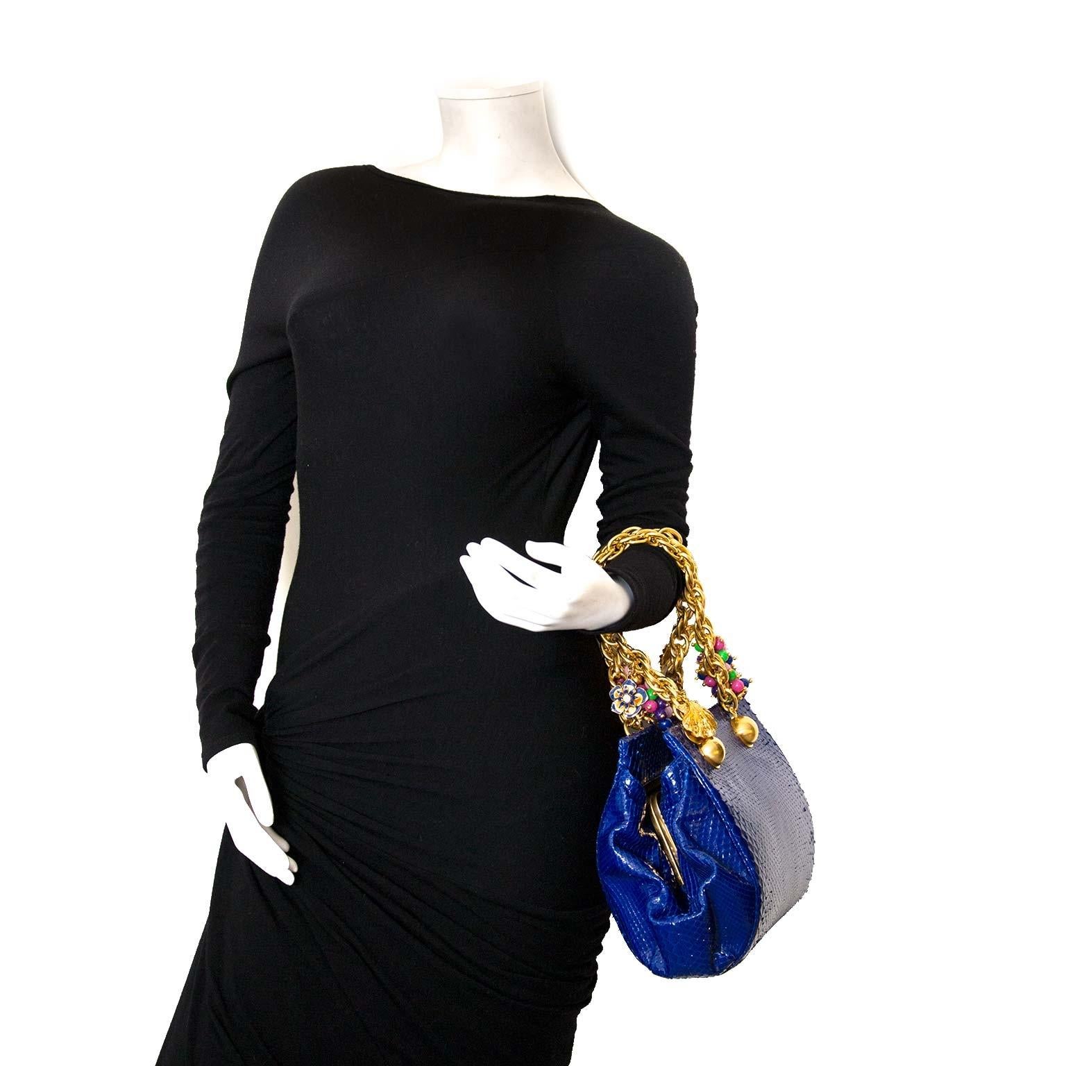 Very good condition

Versace Blue Python Gold Chain Bag

This true statement-piece by Versace will blow you away. The bag is made from bright blue python leather and features a gold chain complete with little ornaments in the shape of flowers,