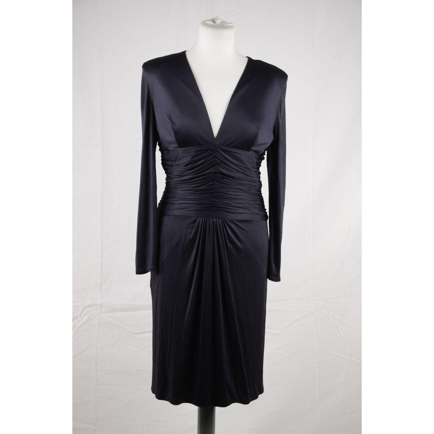 - VERSACE - Made in Italy 
- V-neckline design
- Long sleeve styling with light weight shoulder pads 
- Pleated and Draped detail to the front 
- Fabric / Material: 95% Viscose - 5% Silk 
- Color / Effect: Navy Blue 
- Main Closure: Rear zip closure