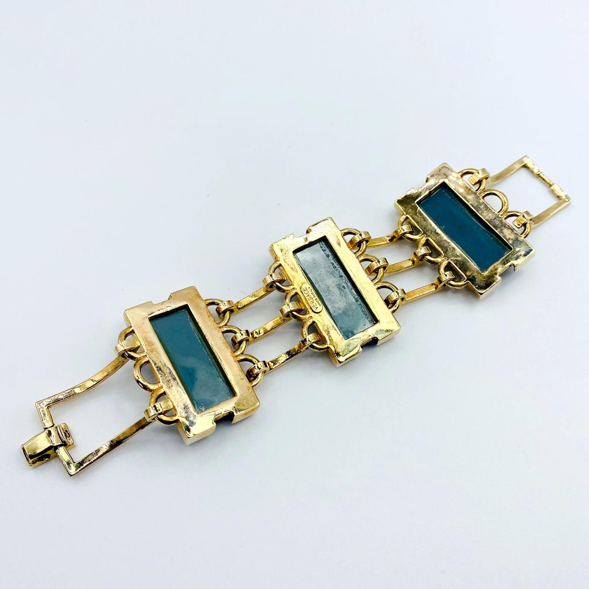 Versace Bracelet  - Preloved Statement Cuff

This exquisite Versace preloved cuff bracelet is a real head-turner! Featuring a gate-style bracelet with three large aquamarine stones, it's a statement piece that will take any outfit to the next