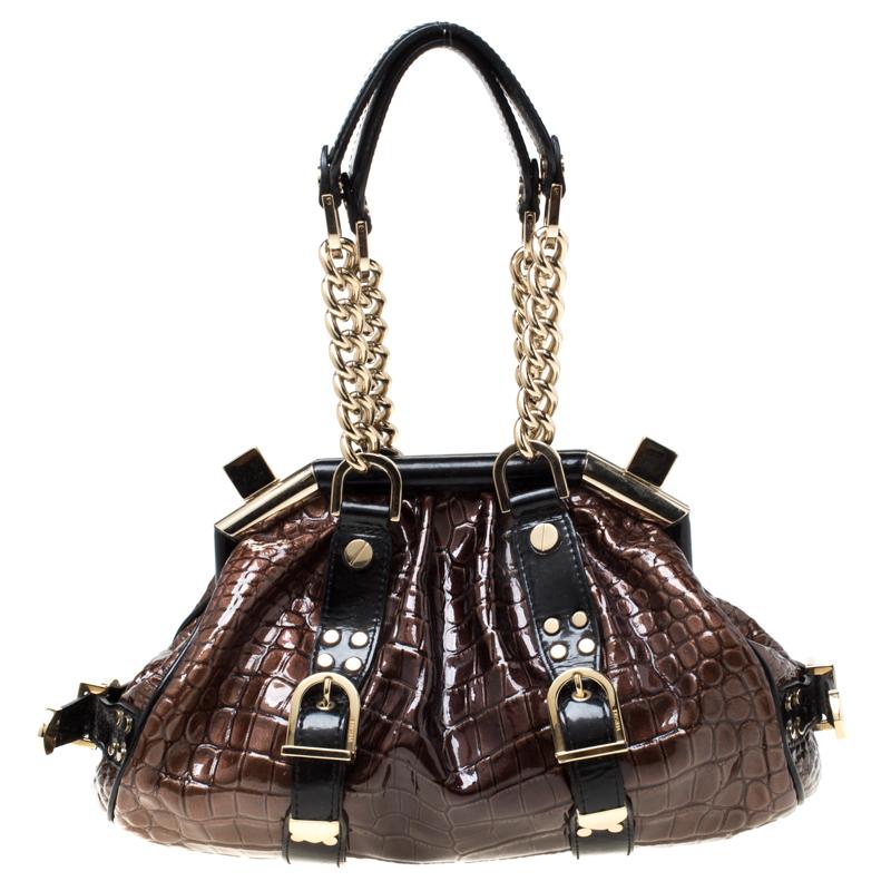 The bag from Versace is made from dual color with thick chain handles attached to metal buckles. This Boston bag is crafted from croc-embossed patent leather and detailed with the logo charm on the front. It is beautifully created to assist you with