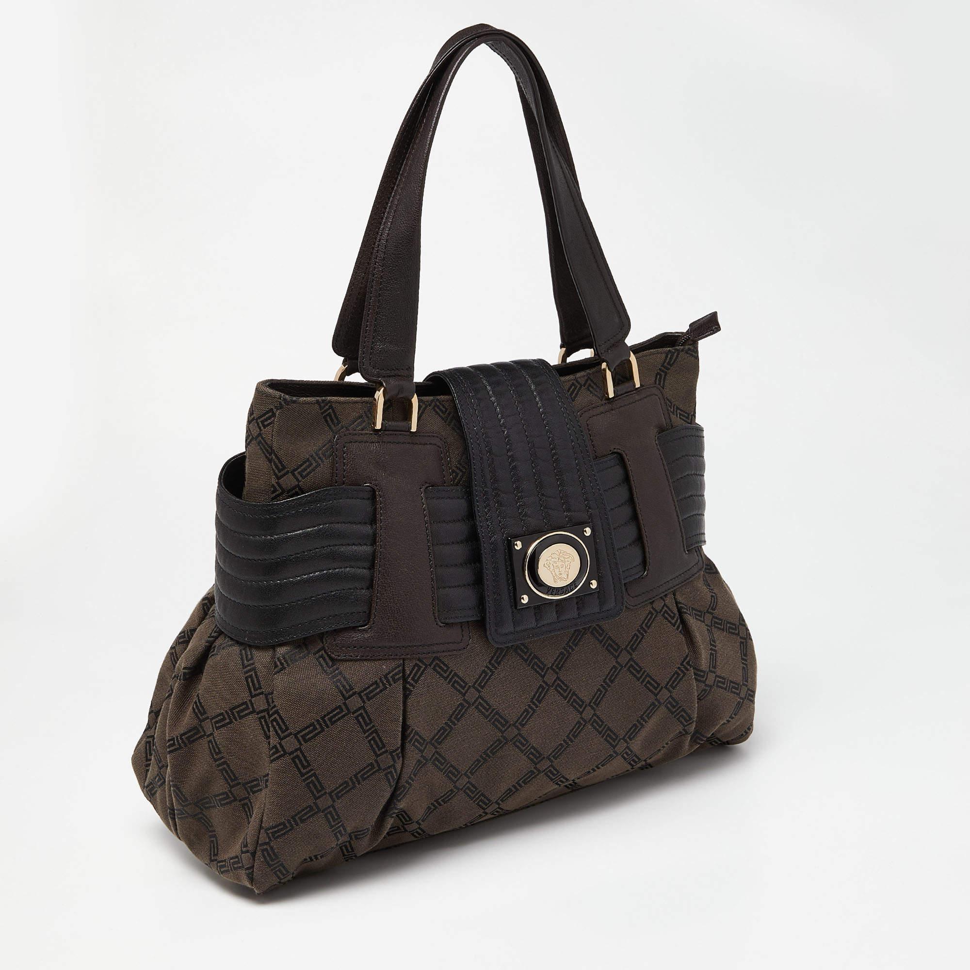 Ensure your day's essentials are in order and your outfit is complete with this Versace tote. Crafted using Monogram fabric & leather, the bag has two handles, the Medusa logo on the front, and a satin-lined interior.

