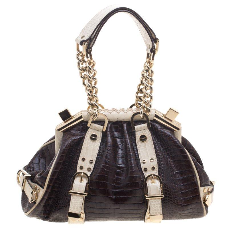 This chic Versace Madonna Boston bag will enhance both your casual and evening wear. Crafted from croc-embossed leather, it is decorated with the iconic Versace motif and gorgeous buckle detailing around the exterior. The bag is equipped with two