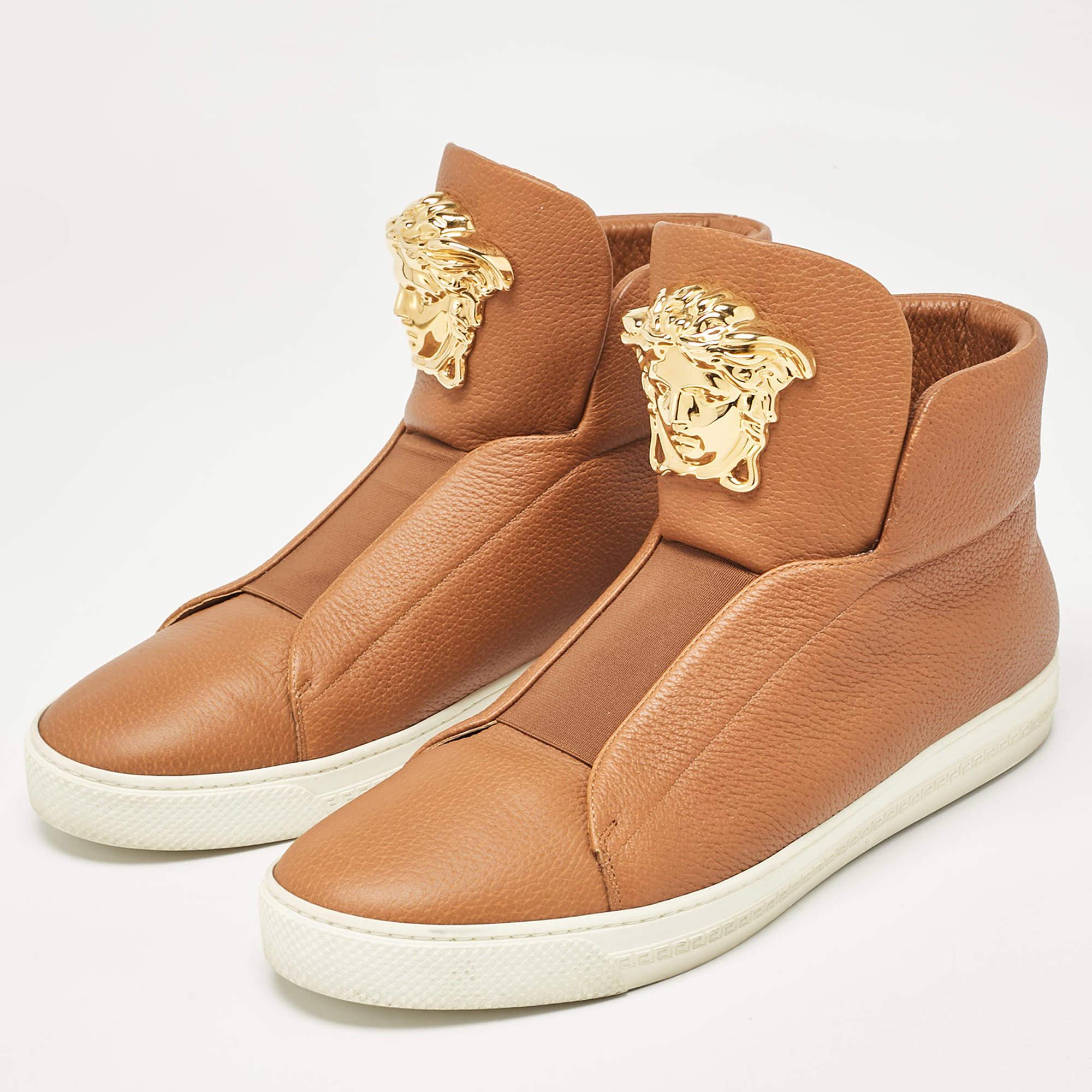 Upgrade your style with these Versace brown high top sneakers. Meticulously designed for fashion and comfort theyre the ideal choice for a trendy and comfortable stride.