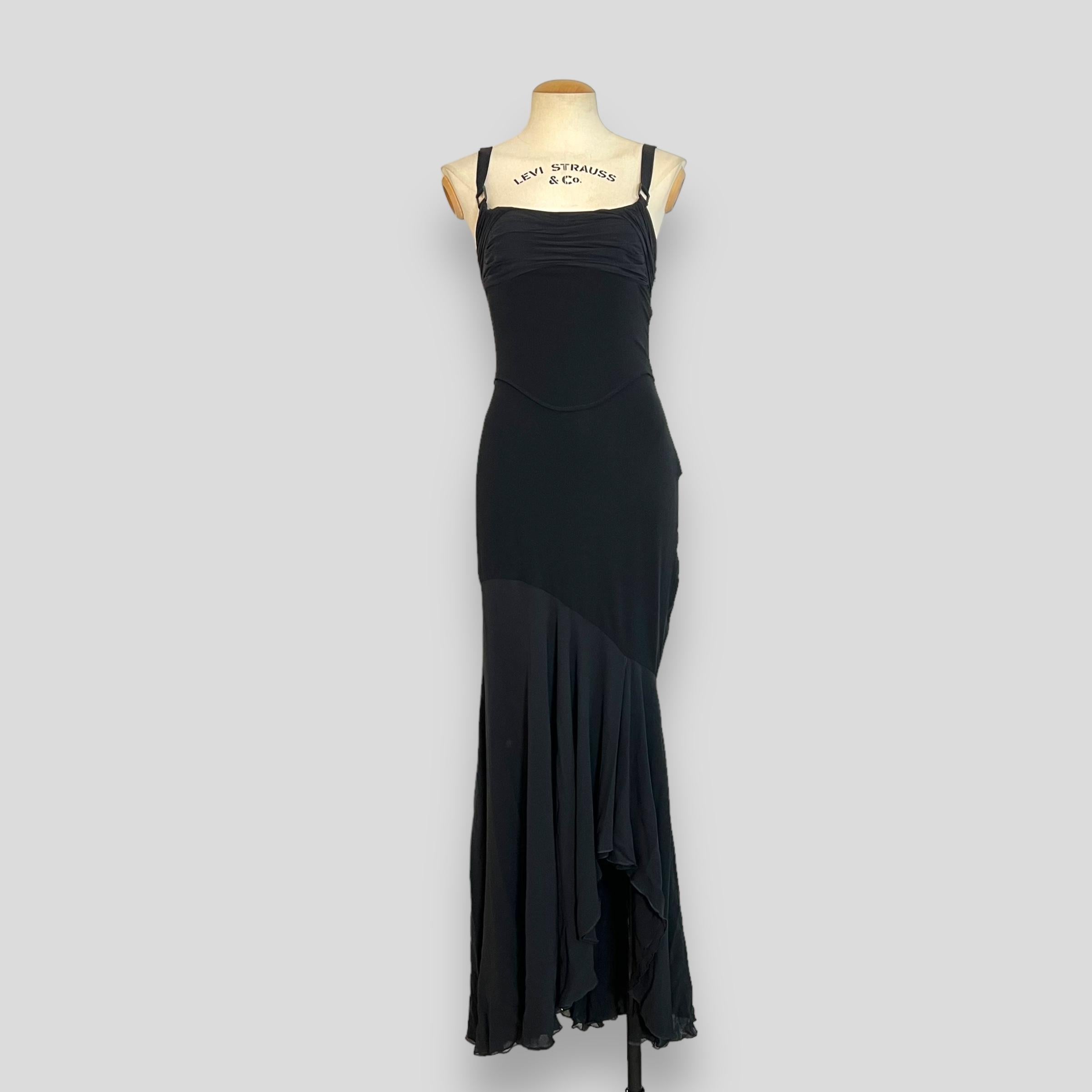 Introducing a sophisticated black gown from the esteemed Fall/Winter 2003 collection by Versace, designed by the iconic Donatella Versace. This floor-length silk masterpiece exemplifies the luxurious and bold aesthetic that Donatella is celebrated