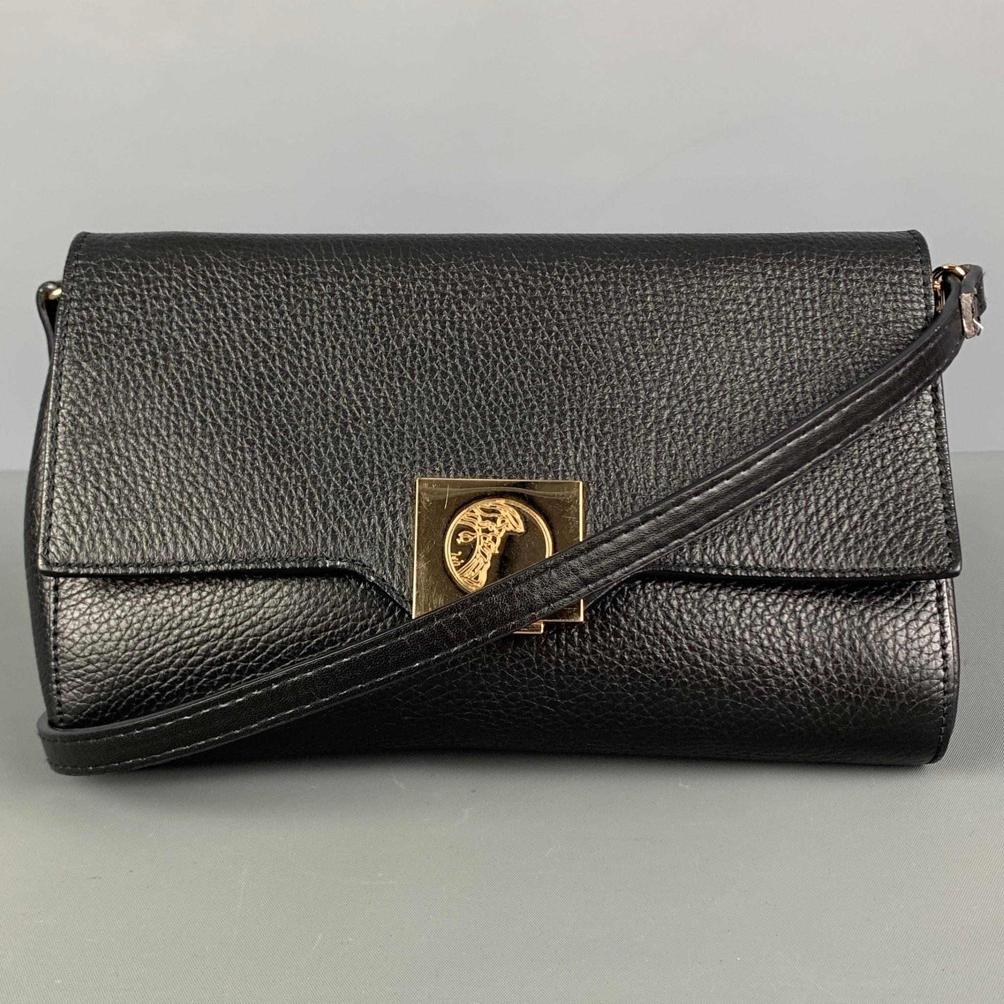 VERSACE COLLECTION handbag comes in a black pebble grain leather, gold tone medusa hardware, inner zipper pocket, replaced detachable shoulder strap, wrist strap, and a push lock closure. Comes with dust bag. Made in Italy.

Very Good Pre- Owned