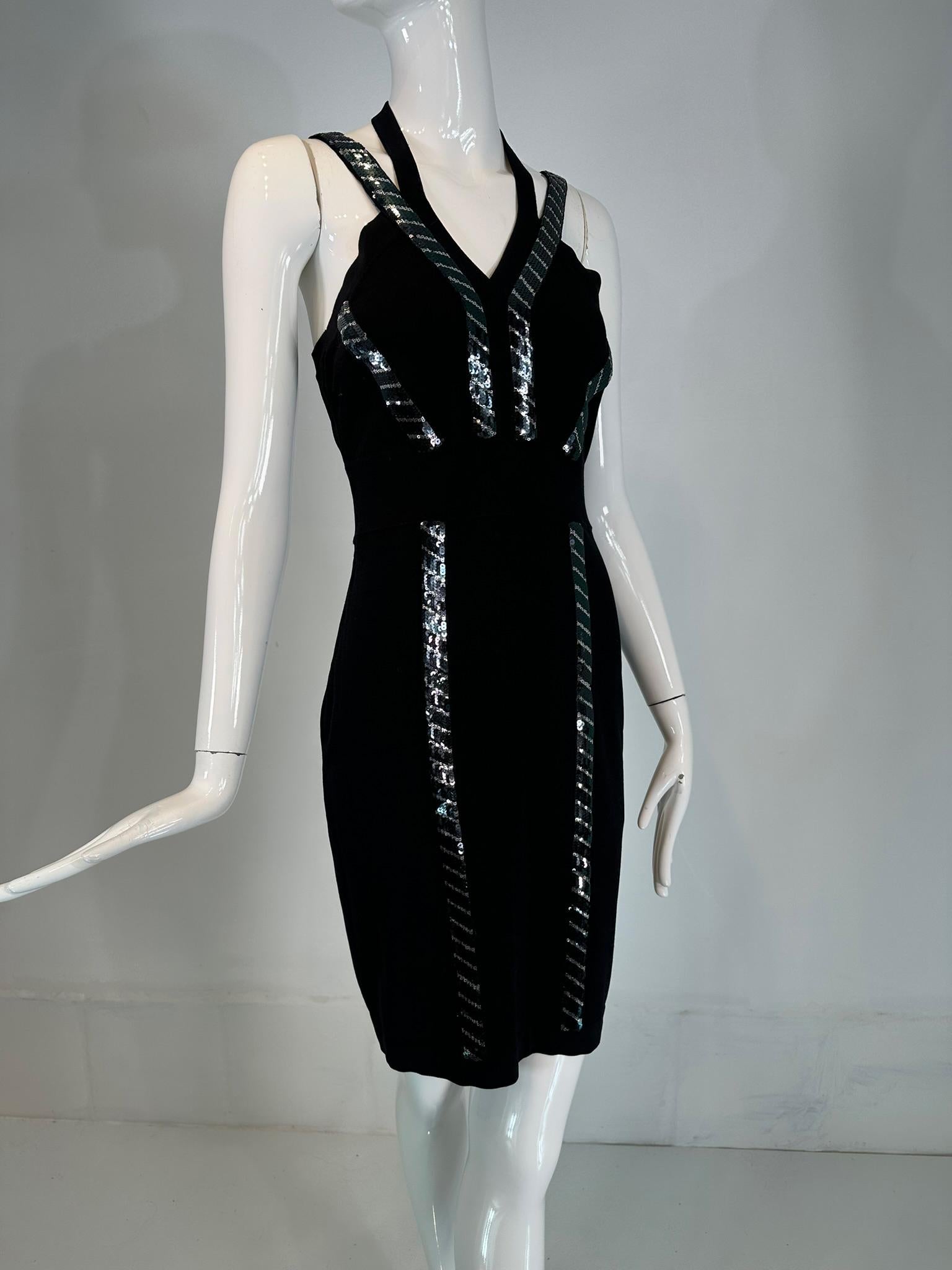 Versace Collection black & silver sequin knit halter neck dress from the early 2000s. Black sweater knit knee length dress, with sequins in black & silver geometric bands. The dress pulls on and closes at the side with a zipper. Halter strap slips