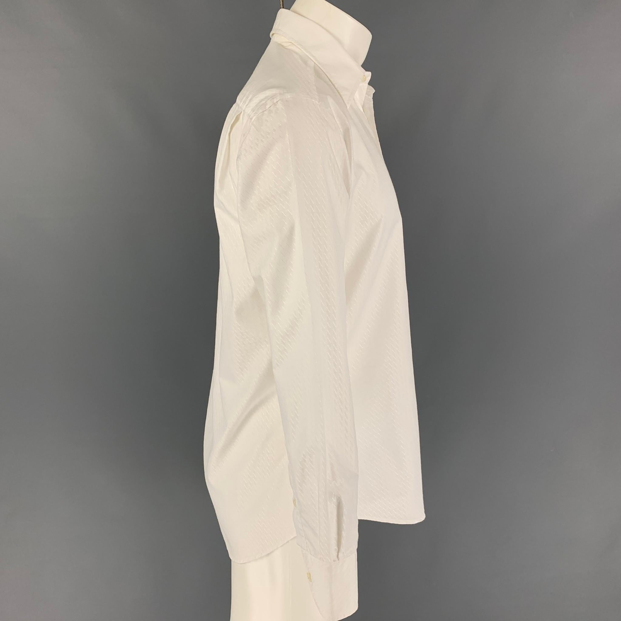 VERSACE COLLECTION 'City' long sleeve shirt comes in white textured cotton featuring a pointed collar and a button up closure. Made in Romania. 

Very Good Pre-Owned Condition.
Marked: 15.5/39

Measurements:

Shoulder: 18.5 in.
Chest: 42 in.
Sleeve: