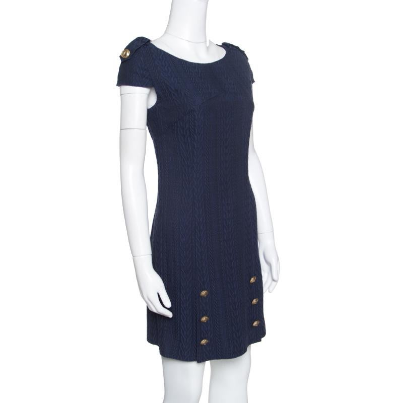 You'll amaze the crowds and fetch never ending compliments in this stunner of a dress from Versace Collection. The navy blue dress is made of a blend of fabrics and features a jacquard knit pattern all over it. It flaunts a boat neckline, shoulder