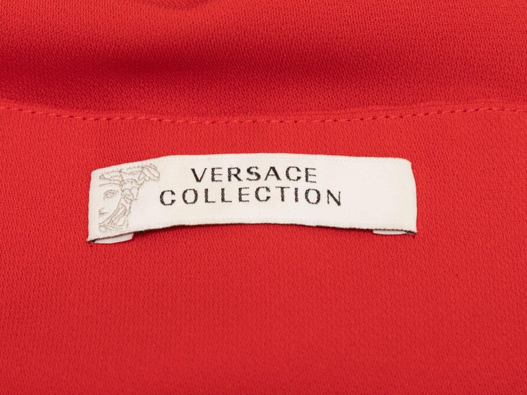 Product Details: Red long sleeve mini dress by Versace Collection. Silver-tone hardware at cutout detailing. Square neckline. Designer size 42. 38