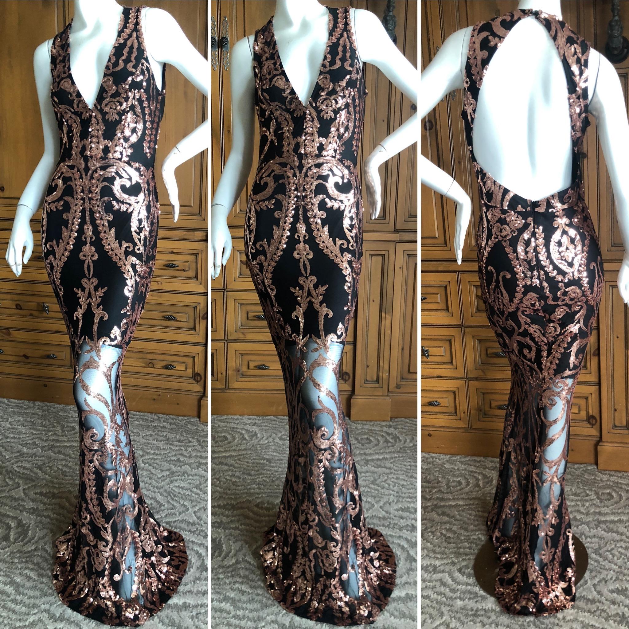 Versace Collection Sheer Net Evening Dress with Baroque Gold Sequin Details.
The lining goes to the knees, but it would be wonderful to remove it completely.
Size 42
Bust 38