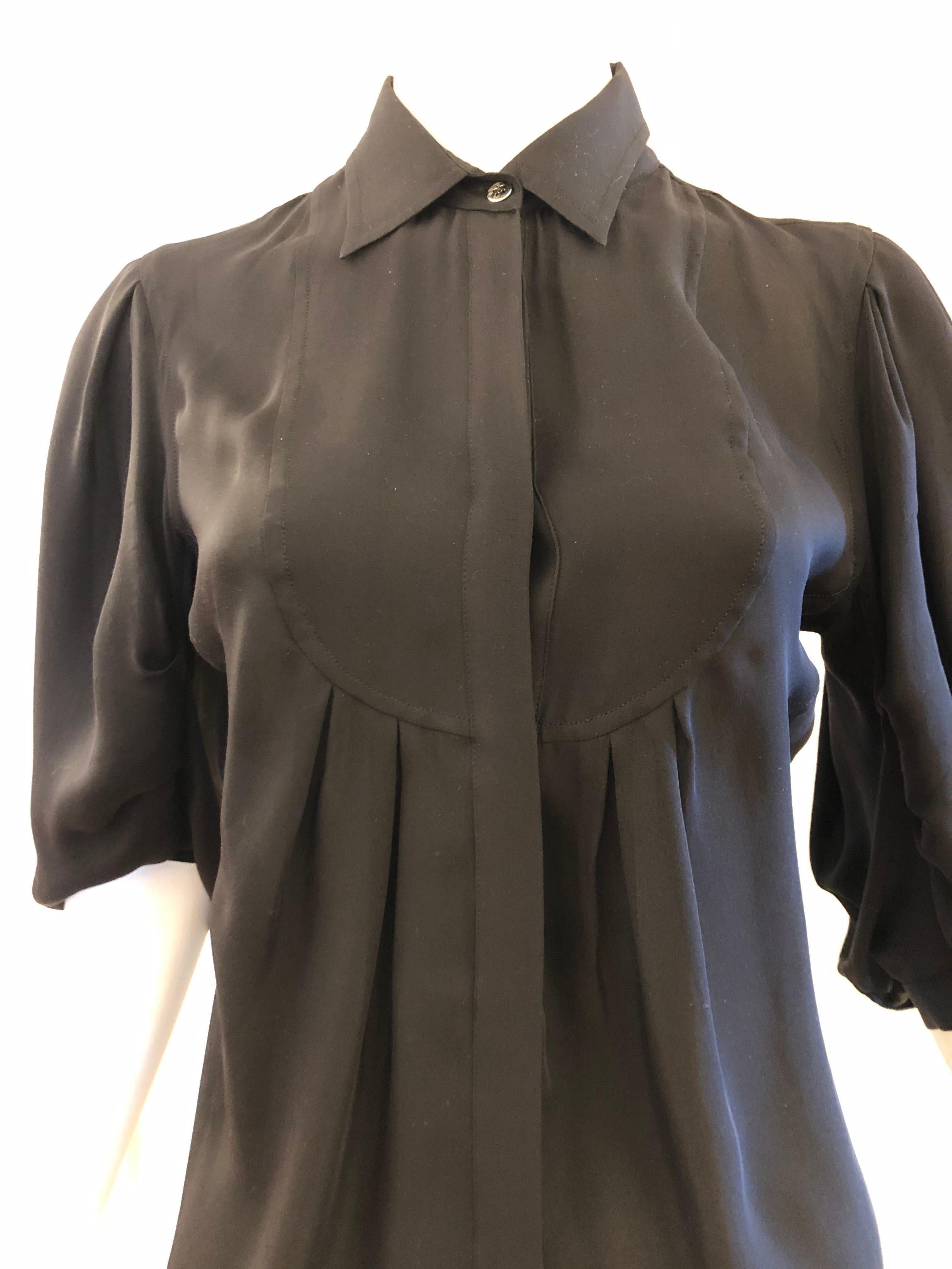 There are so many elements to this blouse including a bib front with pleating; hidden button closure all the way down the front; 3/4 balloon sleeves with light pleating and a beautiful light silk.