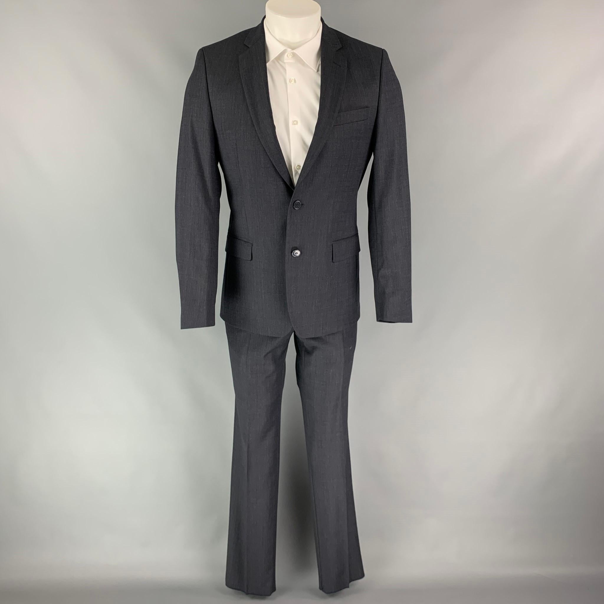 VERSACE COLLECTION suit comes in a charcoal wool with a full liner and includes a single breasted, two button sport coat with a notch lapel and matching flat front trousers.

New With Tags.
Marked: 48

Measurements:

-Jacket
Shoulder: 17 in.
Chest: