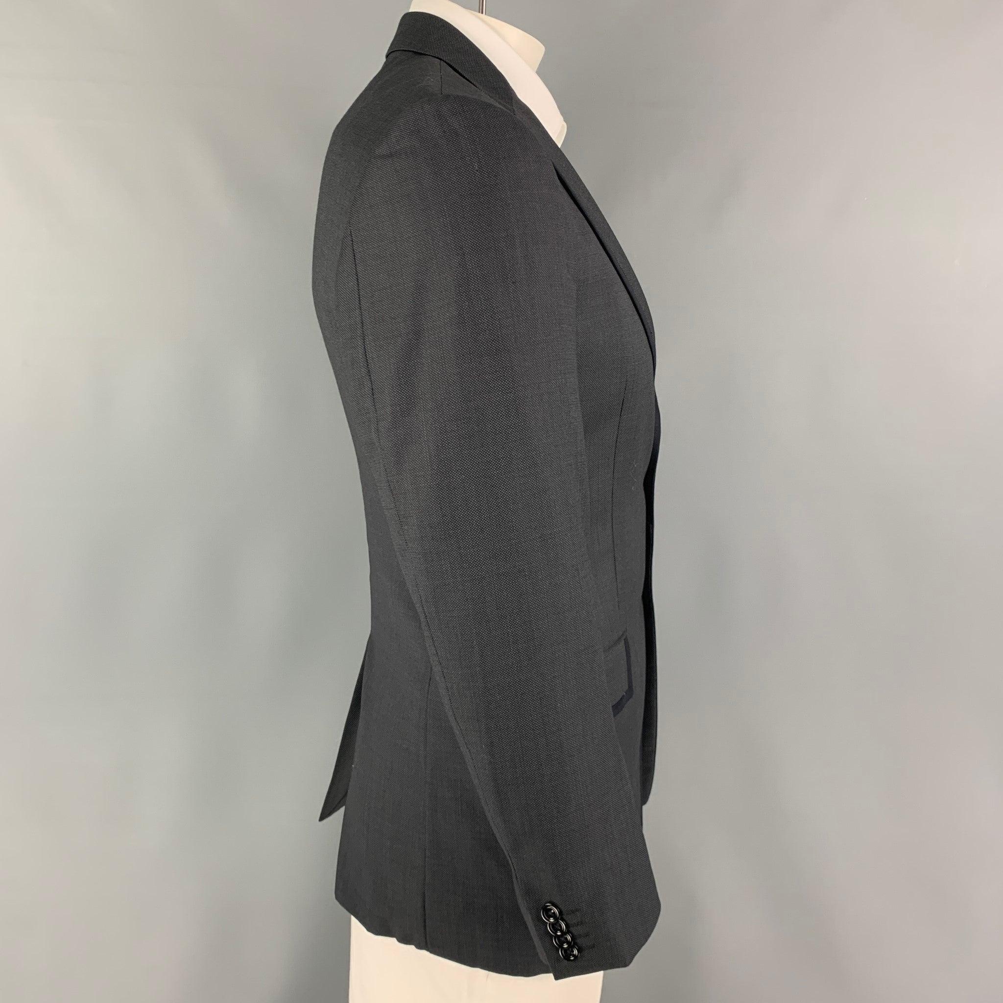 VERSACE COLLECTION sport coat comes in a charcoal & black woven wool with a full liner featuring a notch lapel, flap pockets, single back vent, and a double button closure.
Excellent
Pre-Owned Condition. 

Marked:   50 

Measurements: 
 
Shoulder: