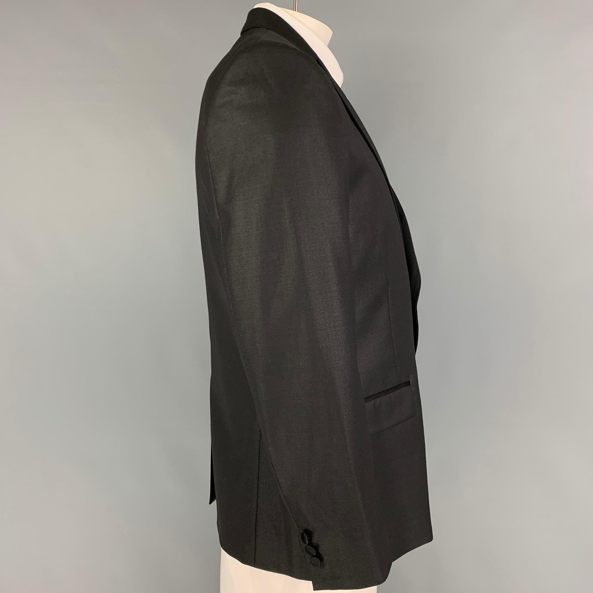 VERSACE COLLECTION sport coat comes in a black polyester blend with a peak lapel, flap pockets, single back vent, and a double button closure.
Very Good
Pre-Owned Condition. 

Marked:   52 

Measurements: 
 
Shoulder:
18.5 inches  Chest: 42 inches 