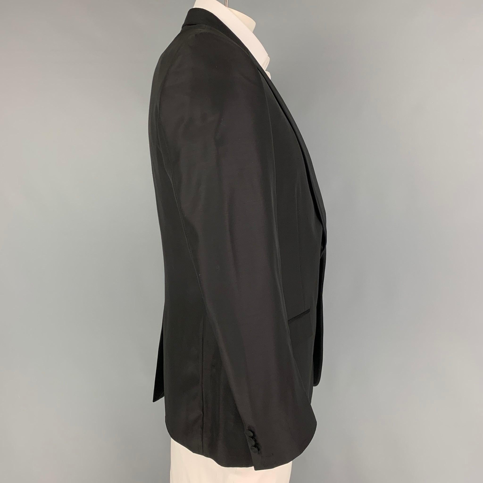VERSACE COLLECTION sport coat comes on a black viscose / wool with a full liner featuring a shawl collar, flap pockets, single back vent, and a double button closure.
Very Good
Pre-Owned Condition. 

Marked:   52 

Measurements: 
 
Shoulder: 18
