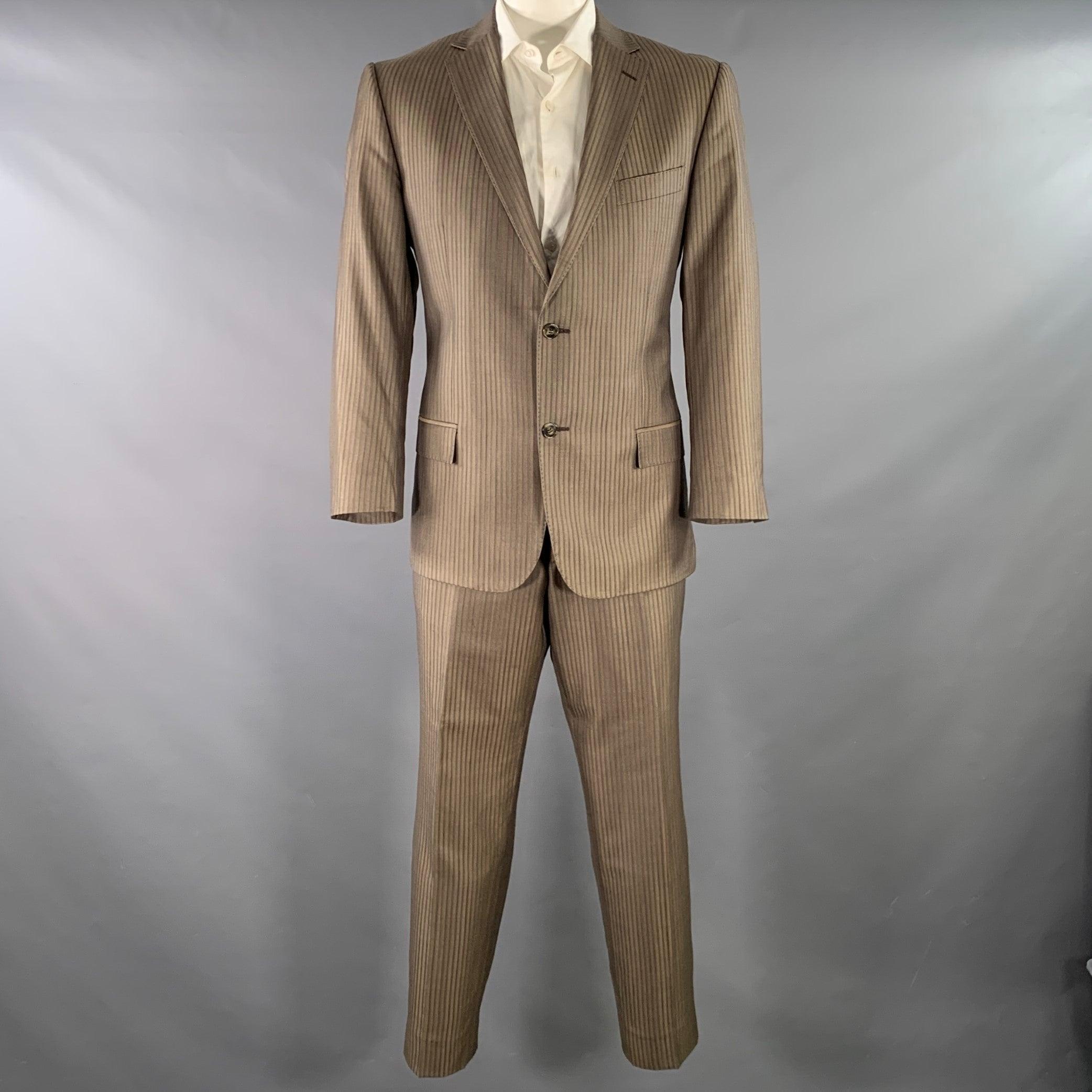 VERSACE COLLECTION suit
in a brown and taupe stripe wool silk blend fabric with a full liner and includes a single breasted, double button sport coat with a notch lapel and matching flat front trousers.Very Good Pre-Owned Condition. 

Marked:   