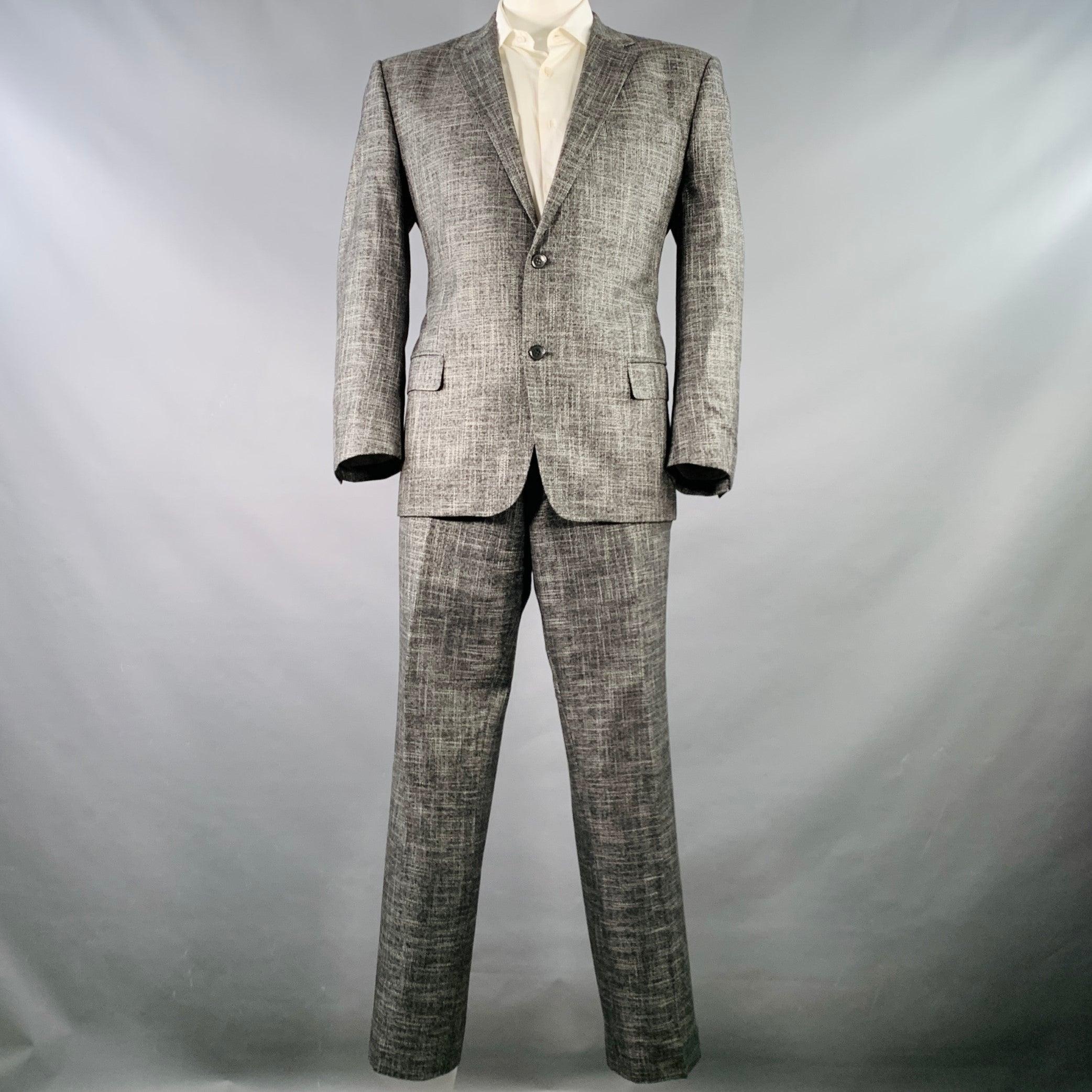 VERSACE COLLECTION suit
in a black & white woven bamboo viscose with a full liner and includes a single breasted, double button sport coat with a notch lapel and matching flat front trousers.Very Good Pre-Owned Condition. 

Marked:   IT 56