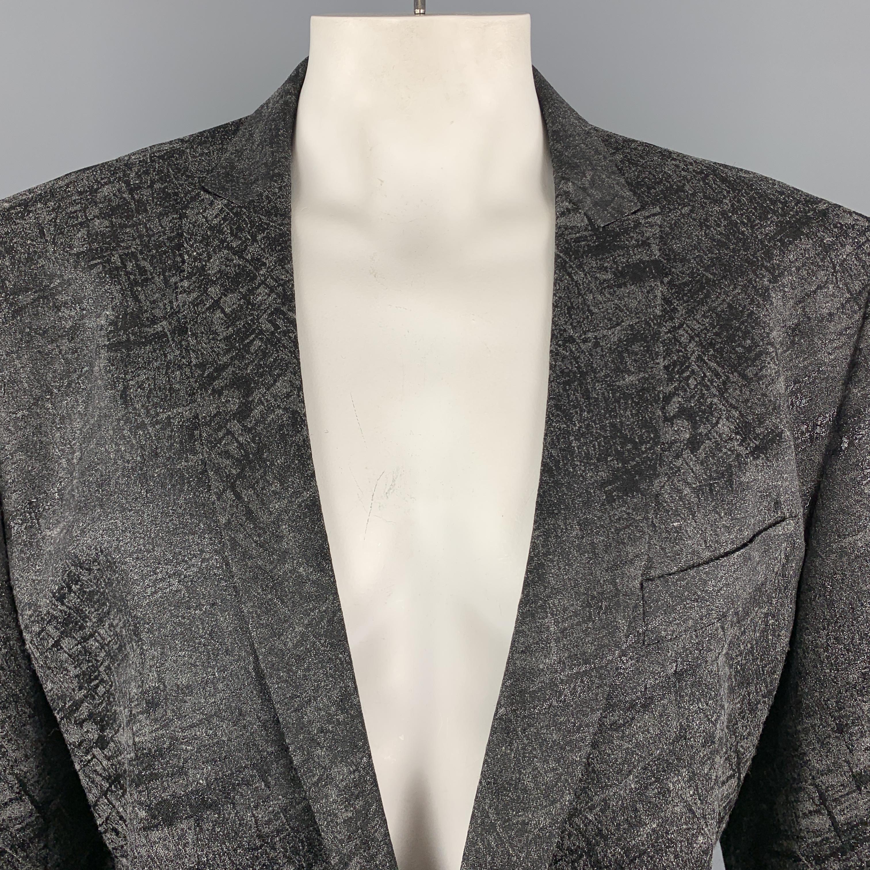 VERSACE COLLECTION sport coat comes in a charcoal and black metallic abstract print jacquard with a skinny peak lapel, single breasted, one  button front, and single vented back.

Excellent Pre-Owned Condition.
Marked: IT