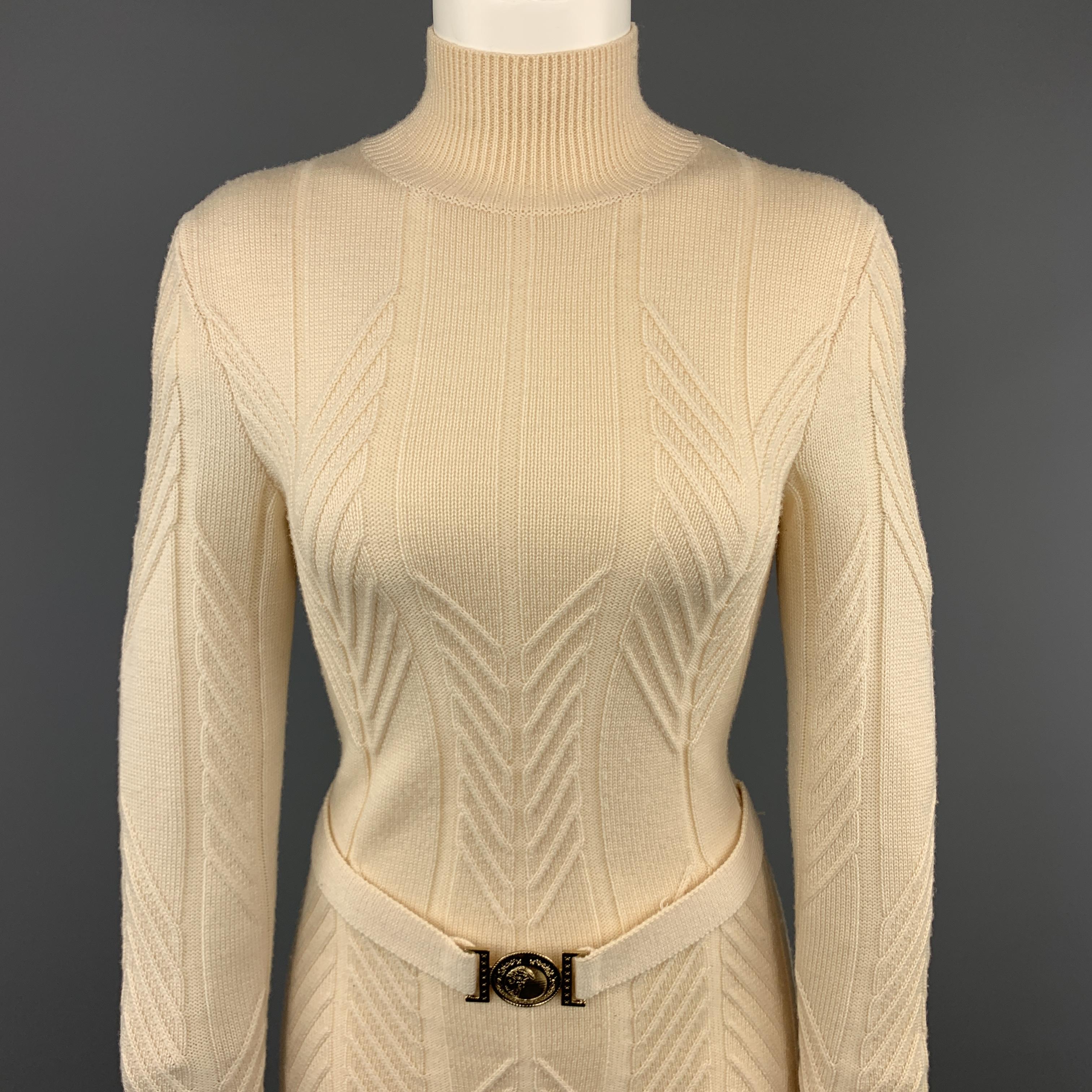 VERSACE COLLECTION pullover sweater comes in cream beige textured knit with a ribbed mock neck and belted front with gold tone Medusa buckle.
 
Very Good Pre-Owned Condition.
Marked: (size tag removed)
 
Measurements:
 
Shoulder: 15 in.
Bust: 34
