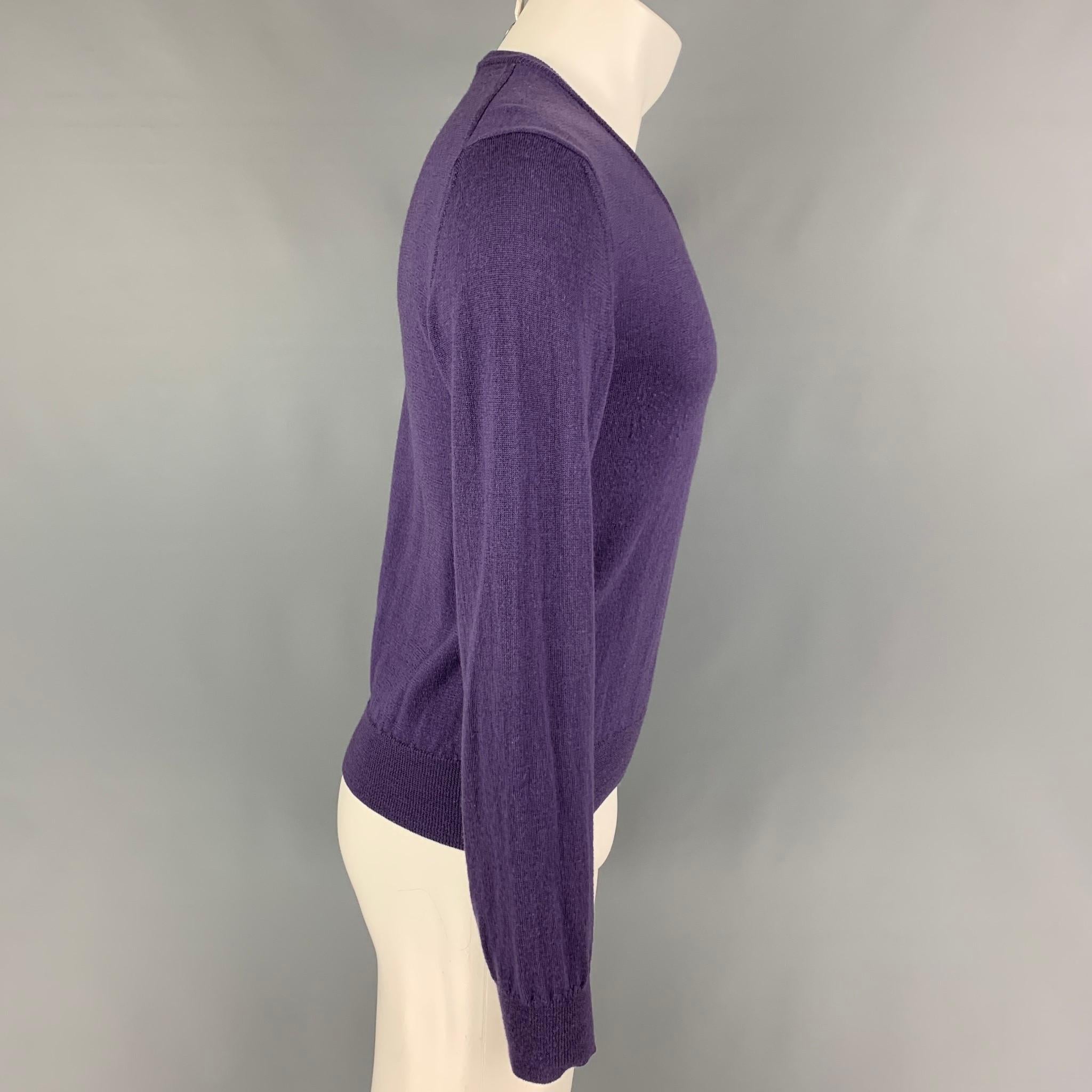 VERSACE COLLECTION pullover comes in a purple wool featuring a embroidered logo and a v-neck. 

Very Good Pre-Owned Condition.
Marked: S

Measurements:

Shoulder: 18 in.
Chest: 36 in.
Sleeve: 26.5 in.
Length: 23 in.