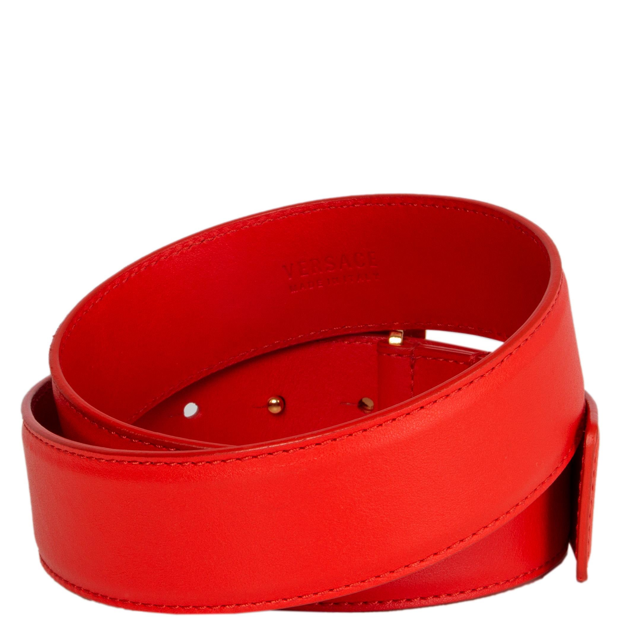 Versace belt in coral red calfskin with a square gold-tone medusa metal buckle. Has been worn and is in excellent condition. 

Tag Size 75
Width 4cm (1.6in)
Fits 70cm (27.3in) to 80cm (31.2in)
Length 91cm (35.5in)
Buckle Size Height 5cm (2in)
Buckle