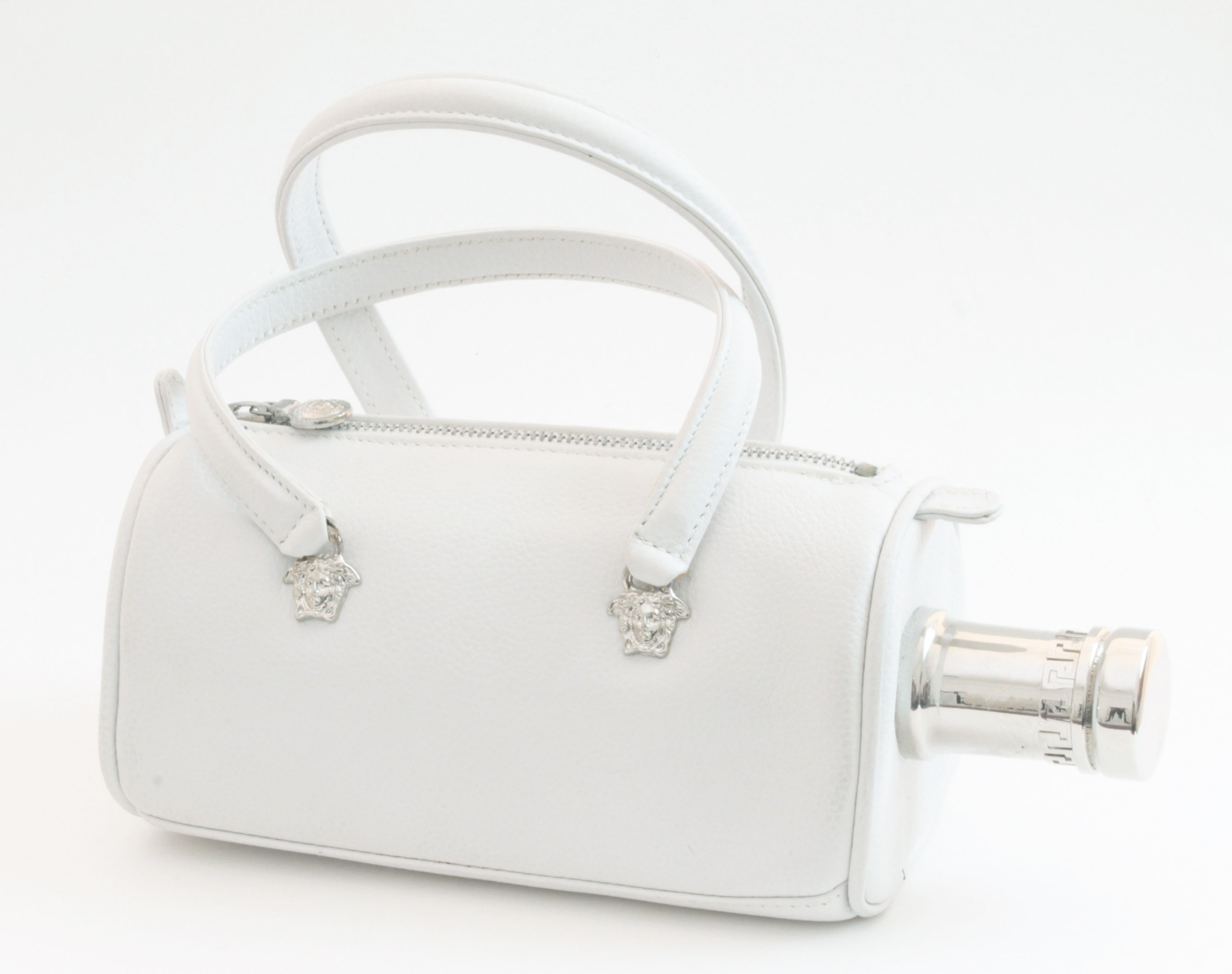 For the true Versace collector! This incredible mini tote was made by Versace Couture for the Absolut Versace ad campaign in 1997.  Made from supple white leather, it features silver Medusa hardware at each handle base and on the zip pull, and a