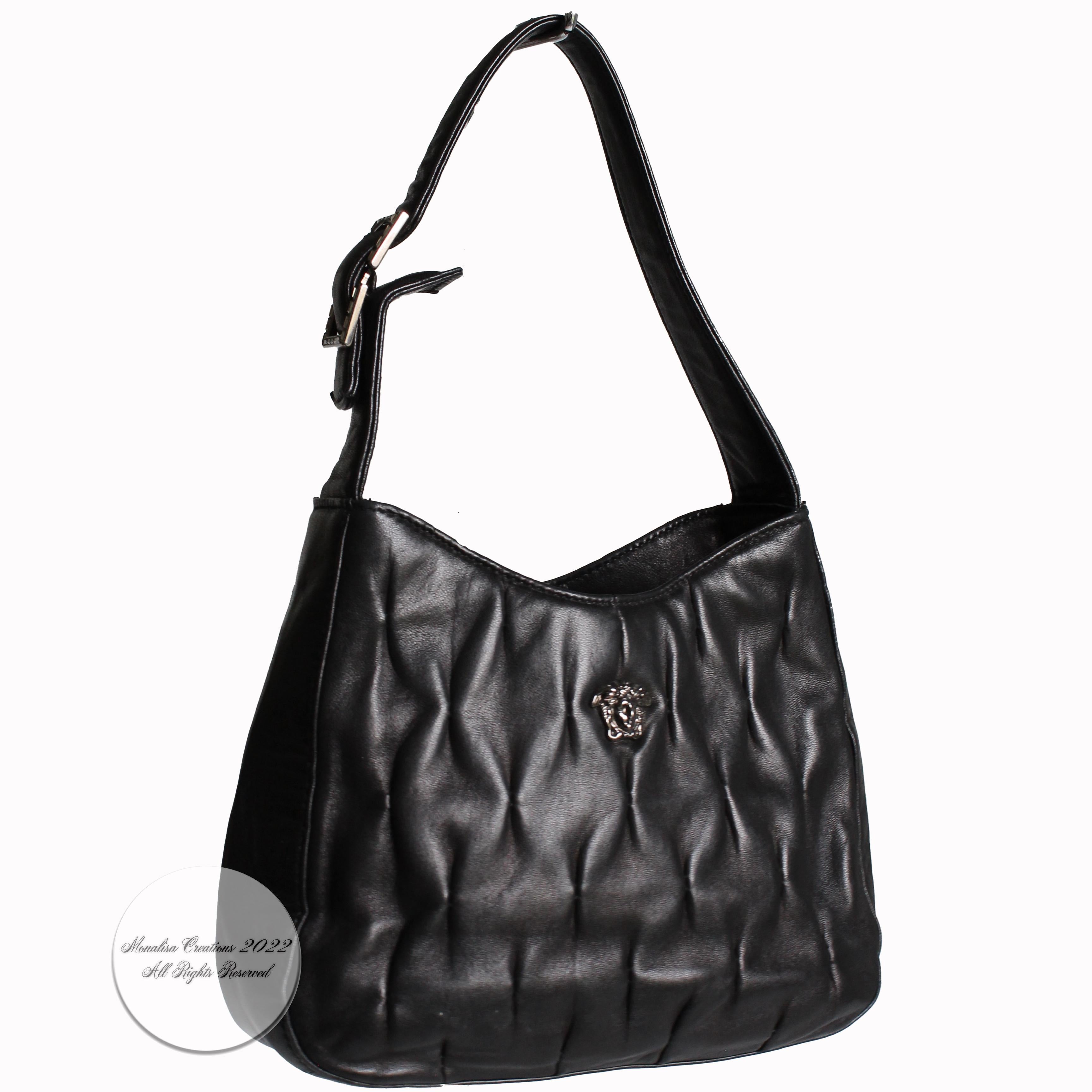 Authentic, preowned, vintage Versace Couture black quilted lambskin Leather evening bag with Medusa, likely made in the 90s. Made from a supple quilted black lambskin, it has a silver Medusa head on front and a decorative jeweled buckle on the